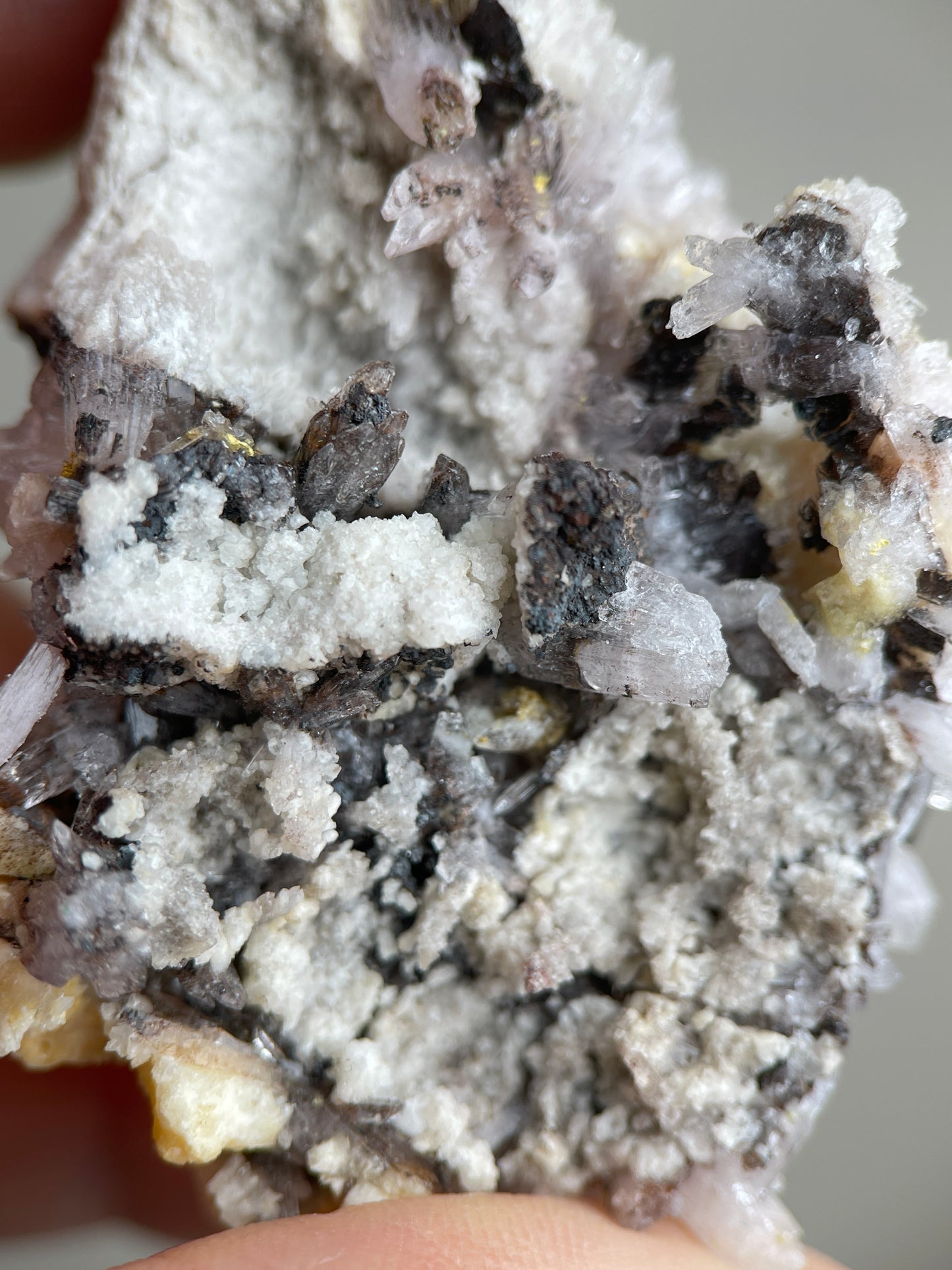 Detail of Creedite crystals with grey and yellow natural matrix texture