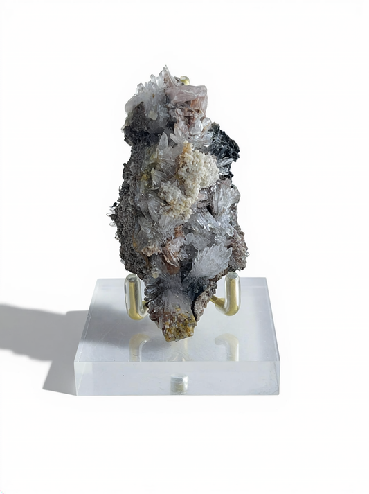 Raw Creedite flower mineral specimen on matrix with display stand