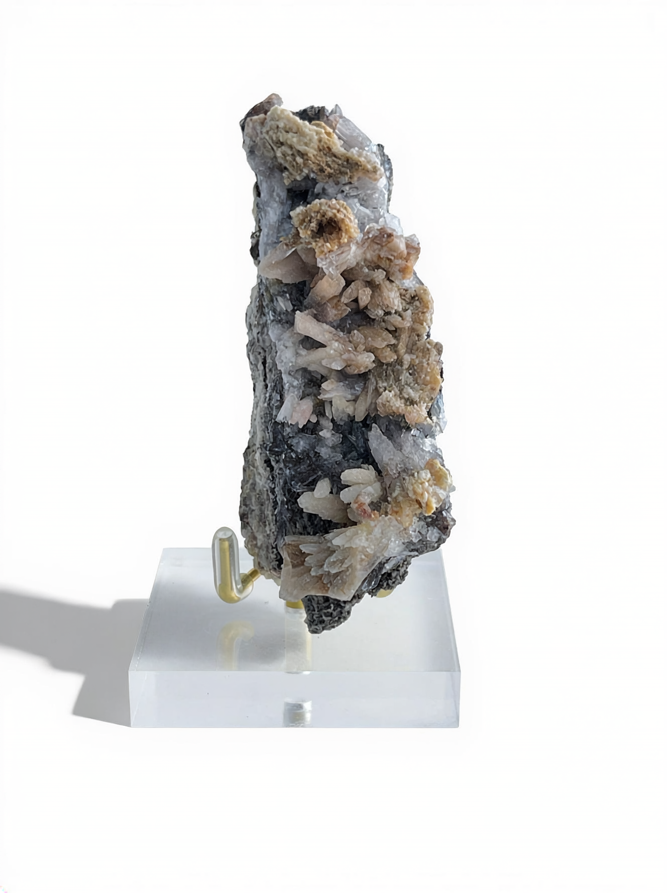 Raw Creedite flower mineral specimen on matrix with display stand