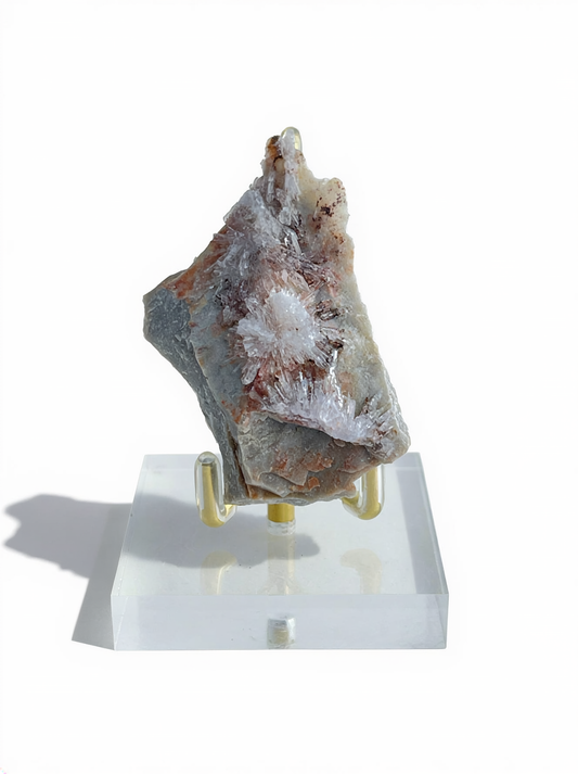 Raw Creedite flower mineral specimen on matrix with display stand