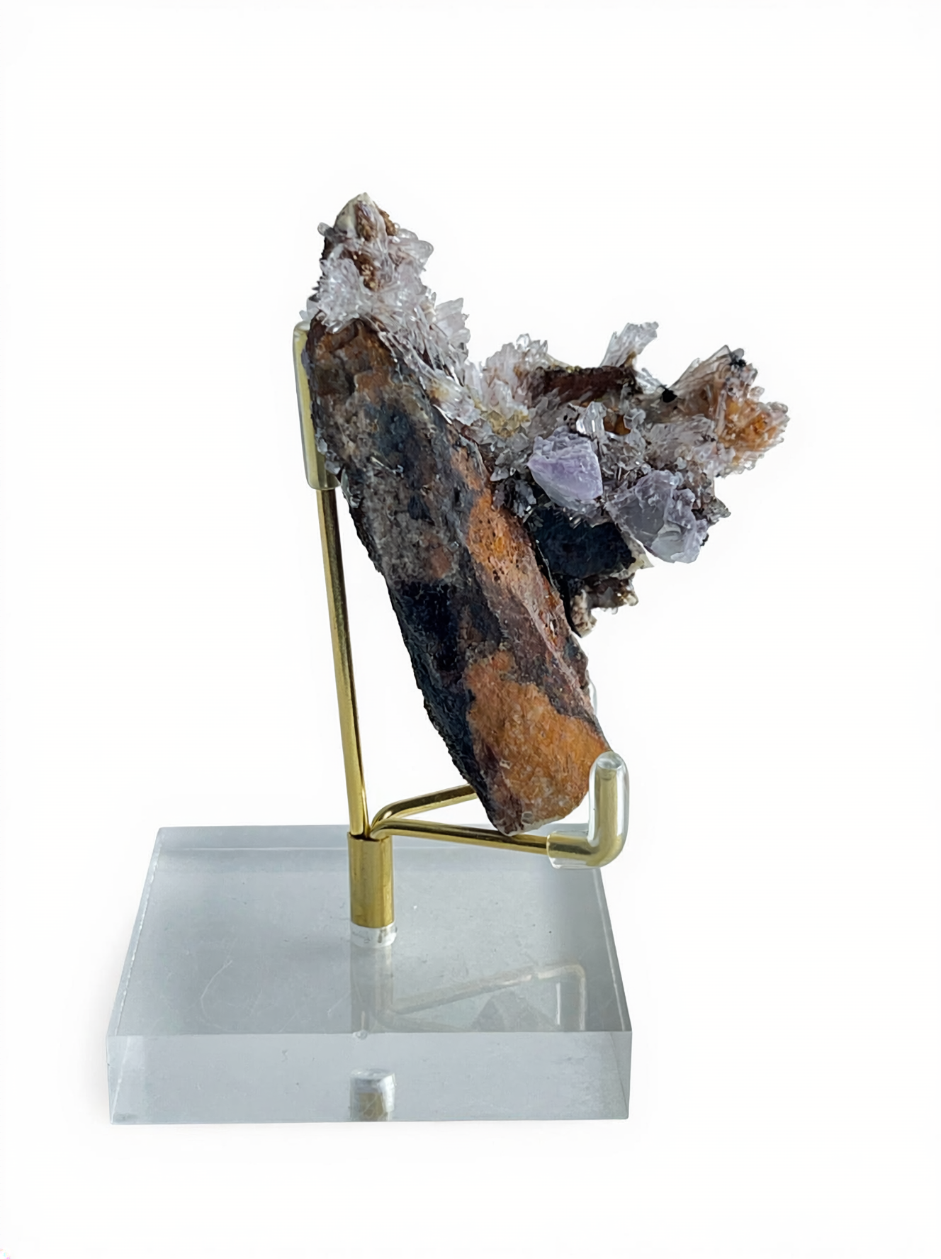Side view of Raw Creedite flower mineral specimen on display stand