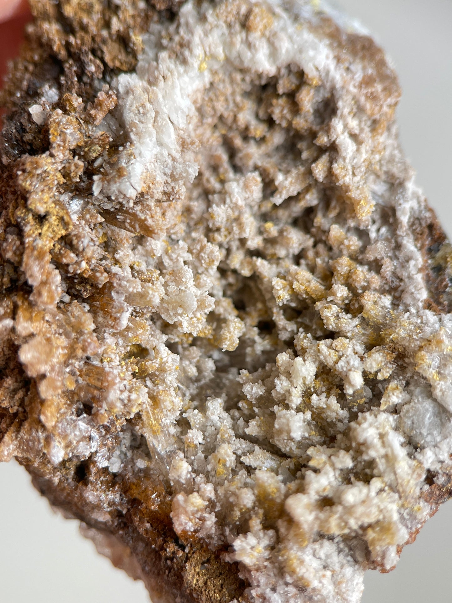 Detail of pale Creedite crystals with golden yellow and brown matrix texture