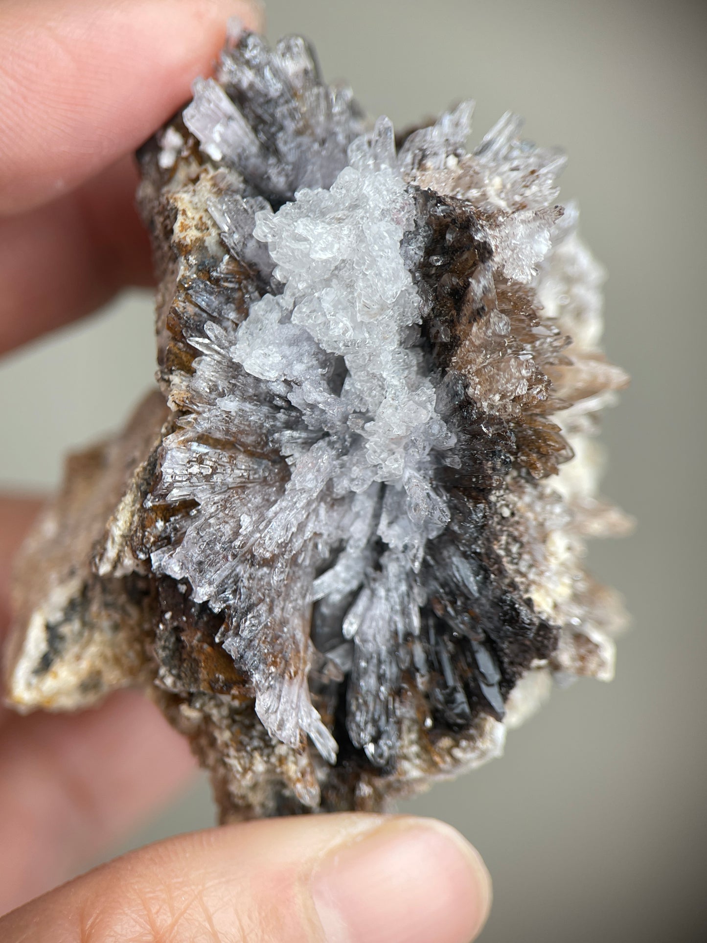 Detail of textured Creedite crystals with beige, grey and dark matrix areas