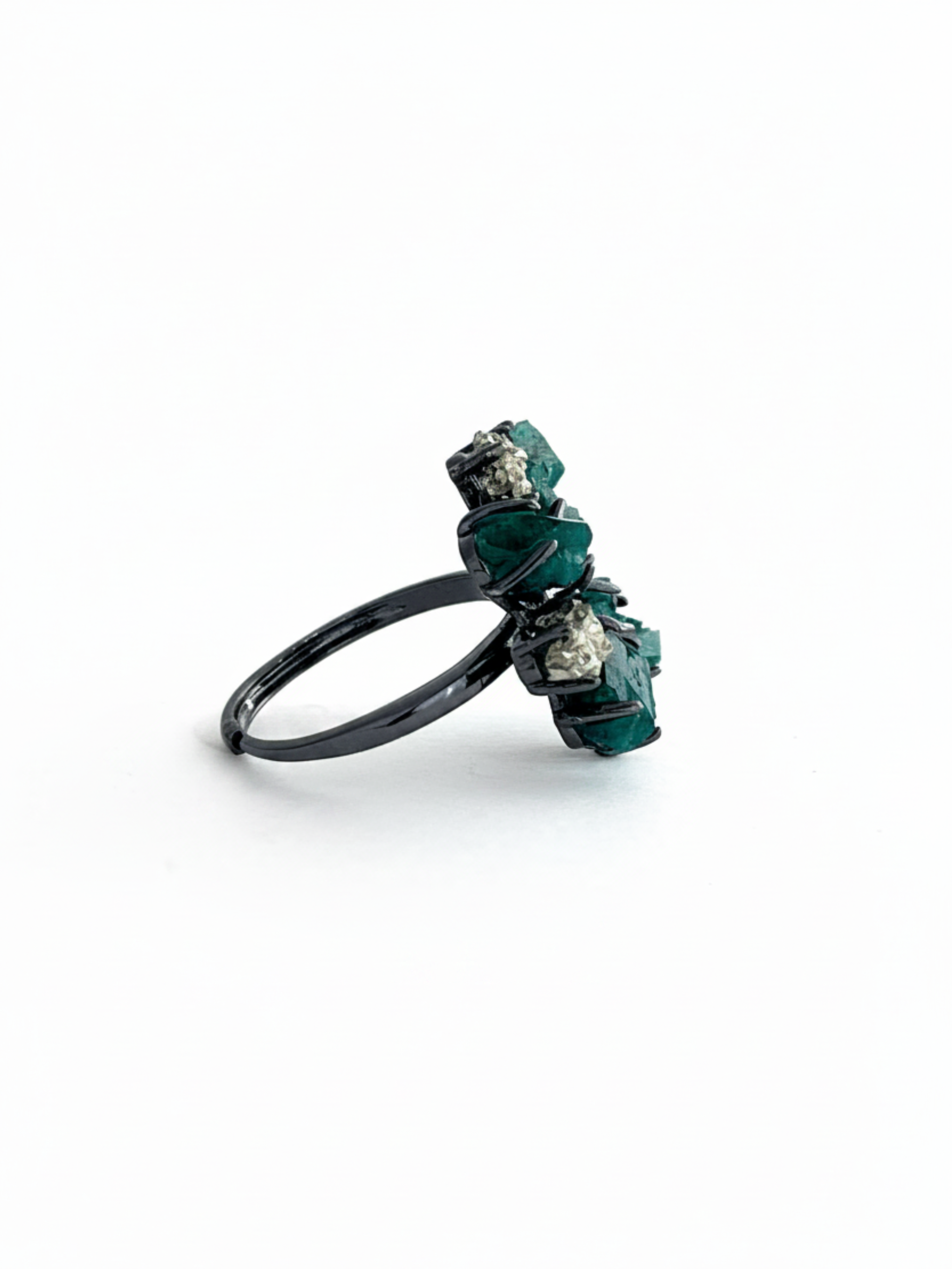 Side view of raw Dioptase and Chalcopyrite ring with black rhodium plated setting