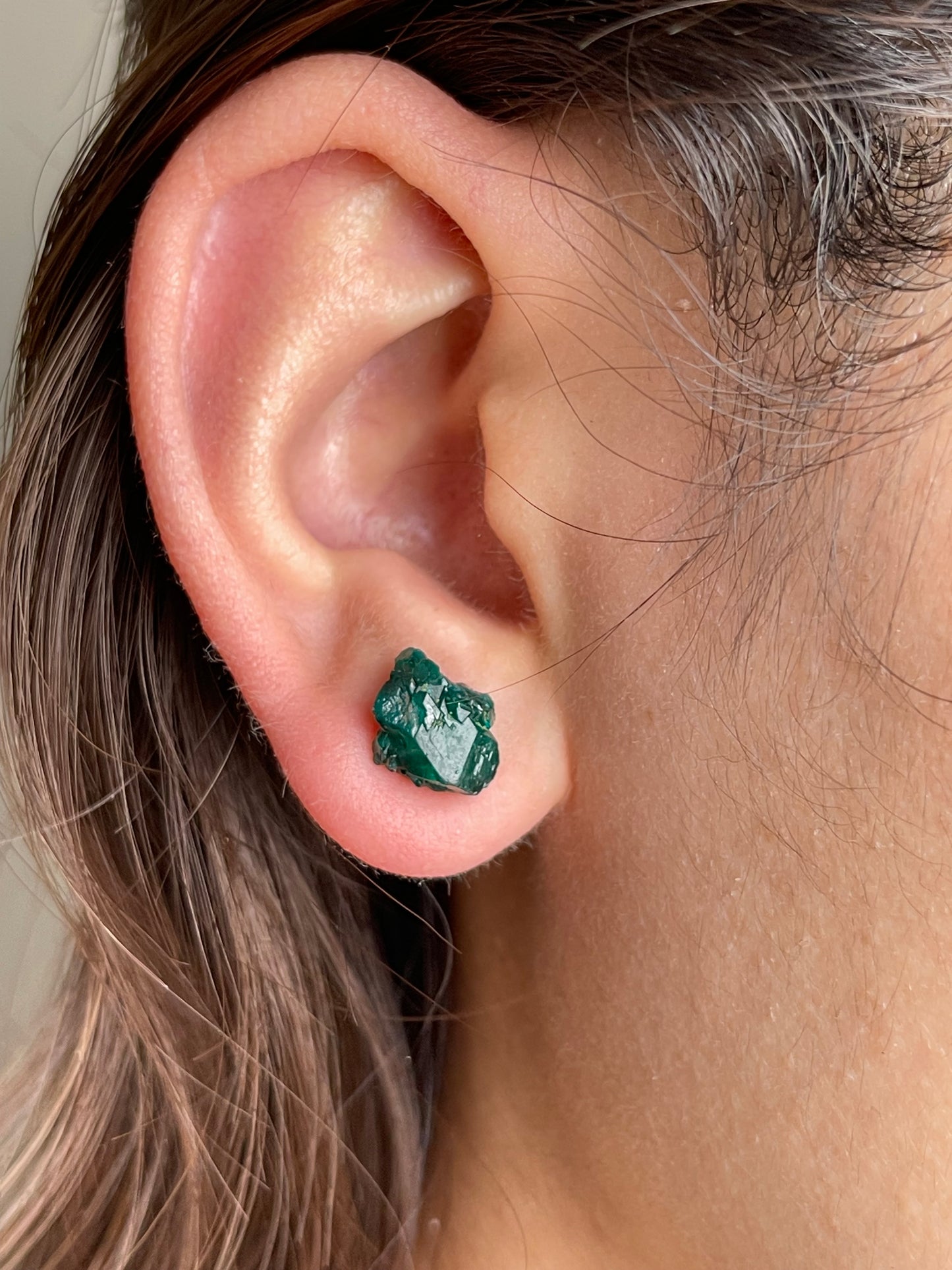 Raw Dioptase Stud Earrings close-up worn on ear