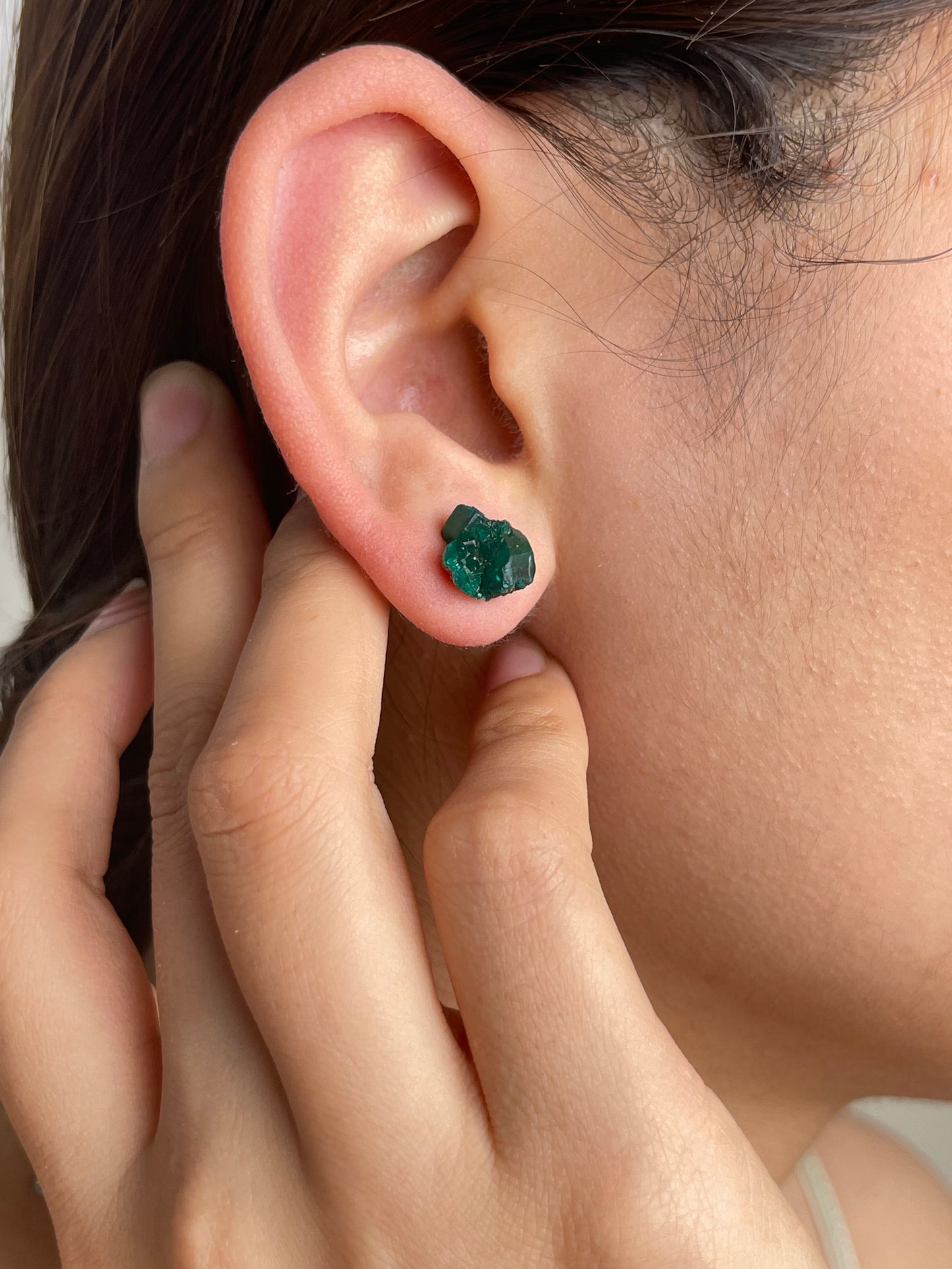 Raw Dioptase Stud Earrings worn on ear