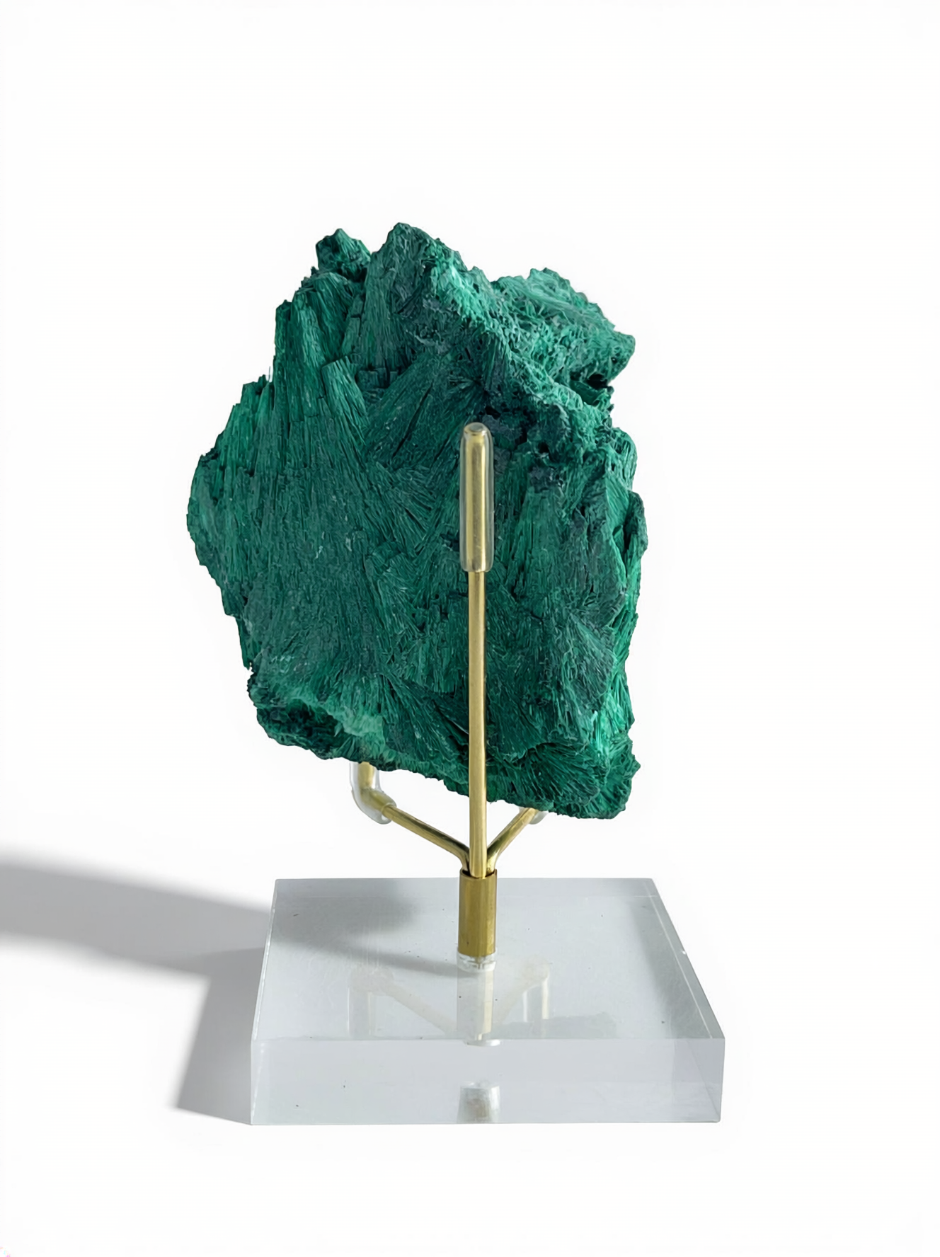 Back view of raw fibrous malachite fan cluster mineral specimen on acrylic display stand
