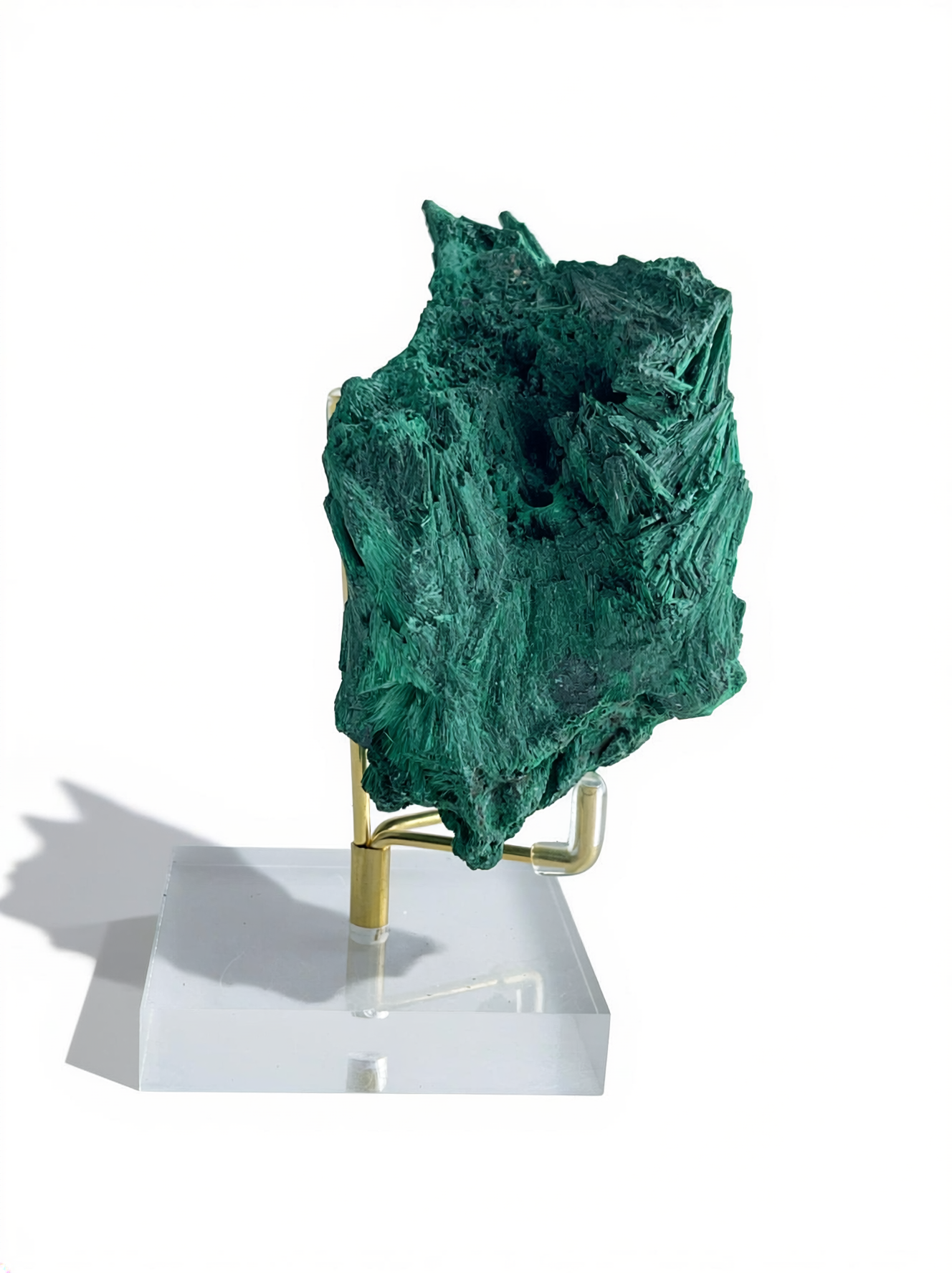 Raw fibrous malachite fan cluster mineral specimen on display stand, side view