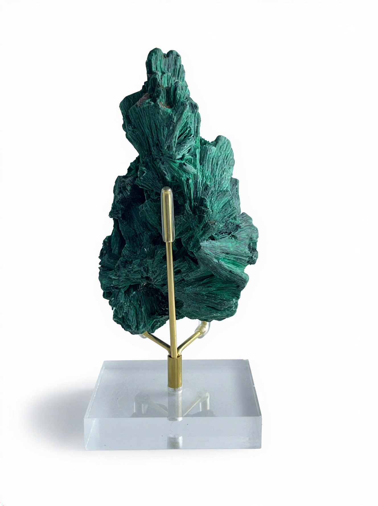 Back view of raw fibrous malachite mineral specimen on acrylic display stand