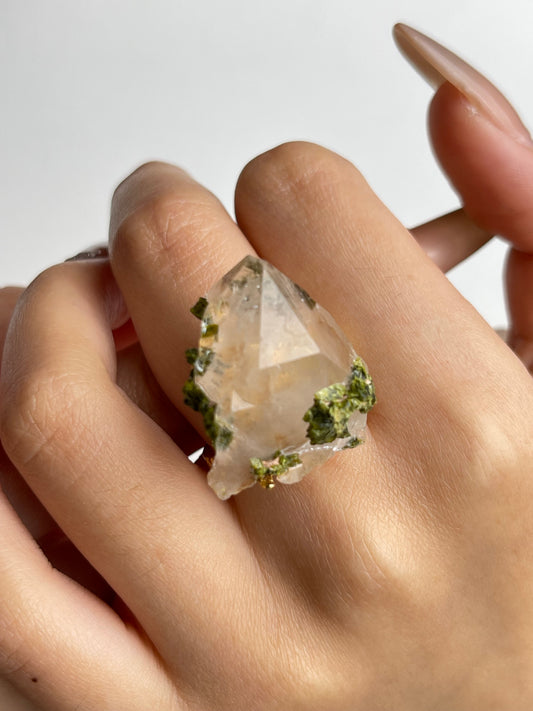 Raw garden quartz epidote ring worn on hand close-up