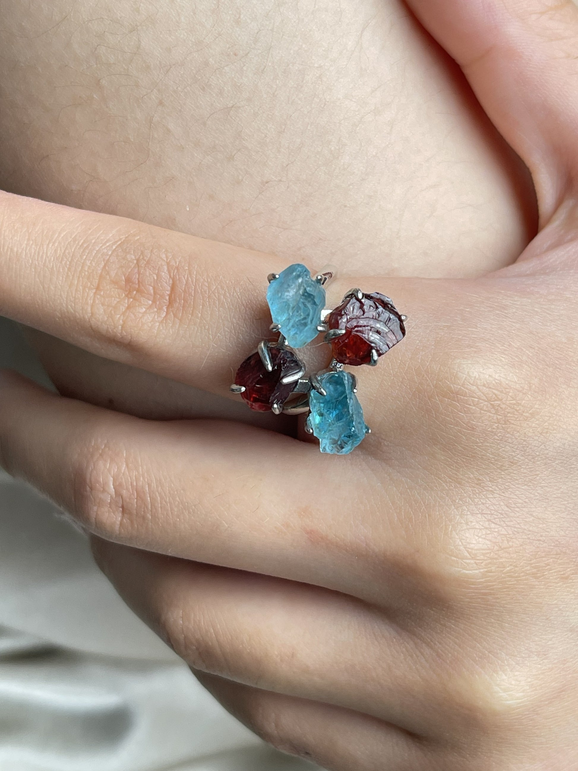 Close-up hand view of Raw Garnet and Blue Apatite crystal ring