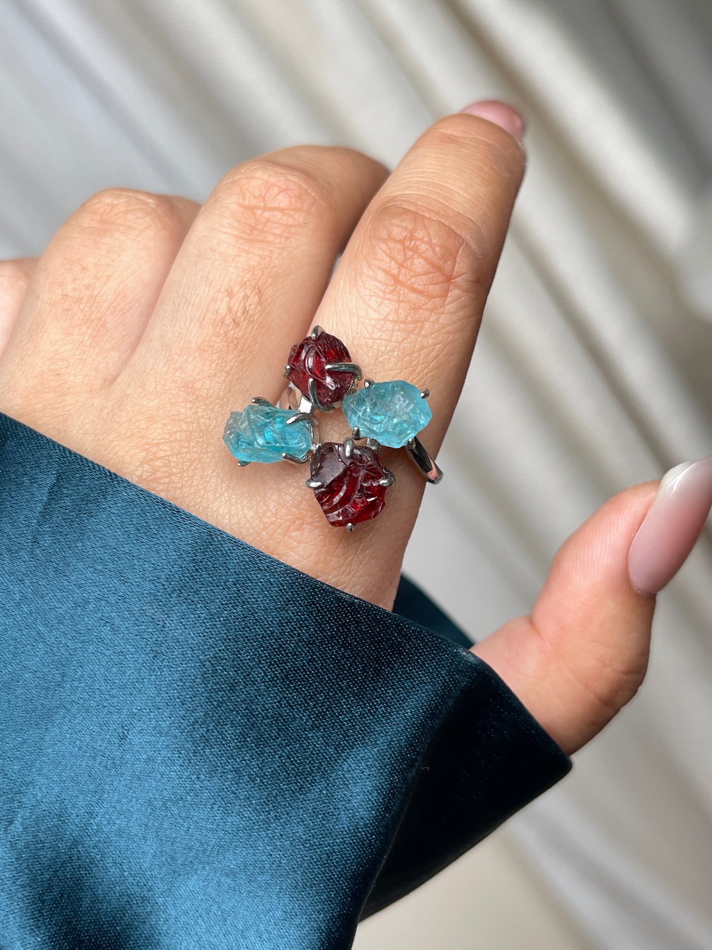 Close-up hand view of Raw Garnet and Blue Apatite crystal ring