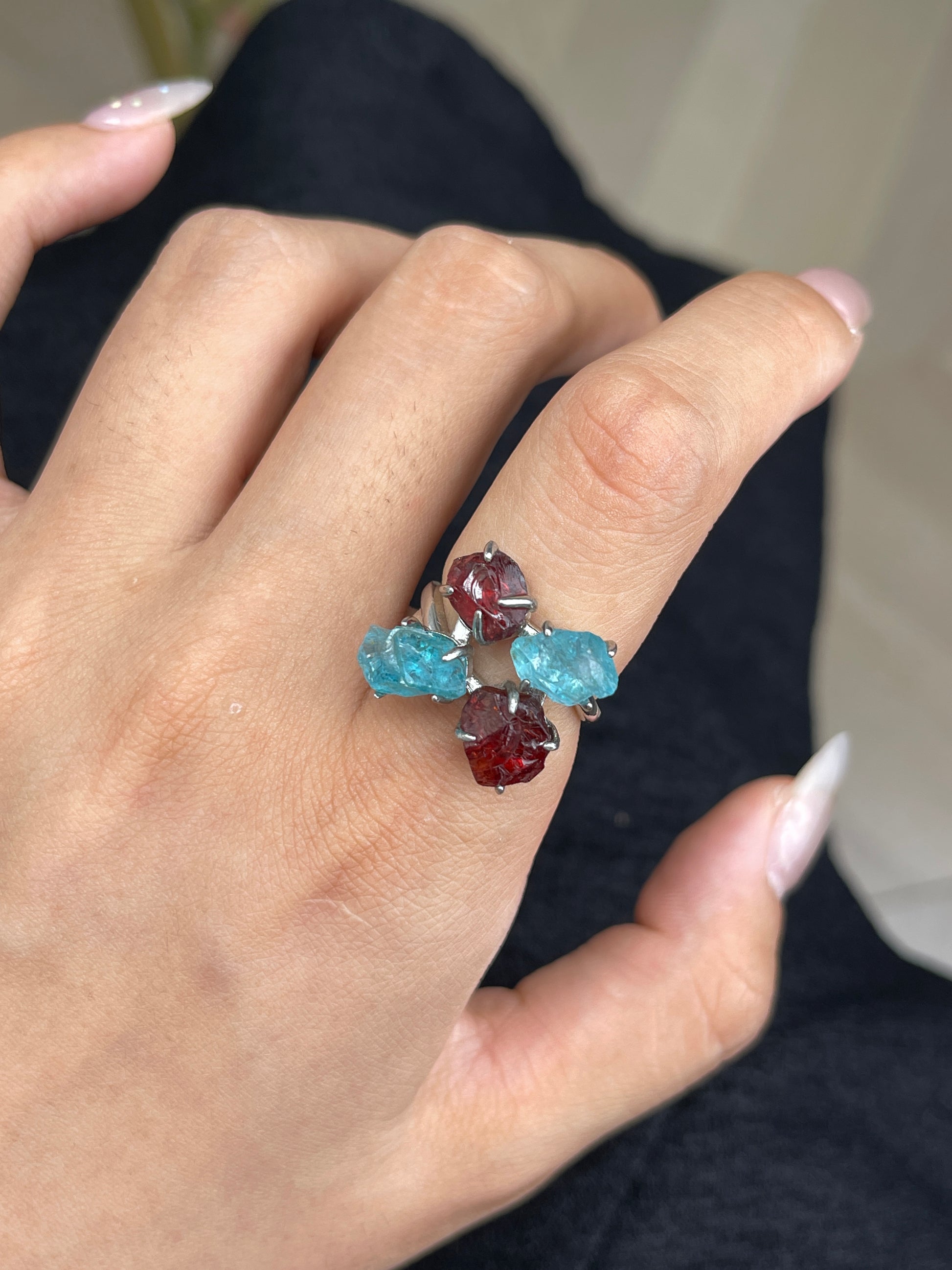 Close-up hand view of Raw Garnet and Blue Apatite crystal ring