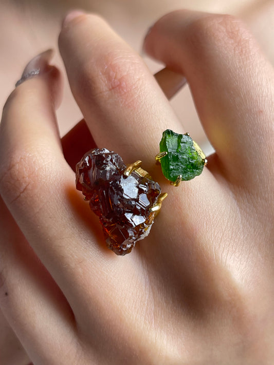 Close-up hand shot of raw garnet and chrome diopside ring