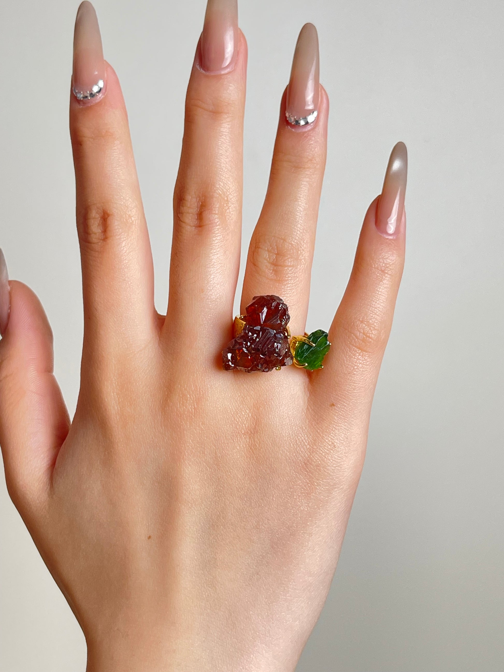 Hand shot of raw garnet and chrome diopside ring