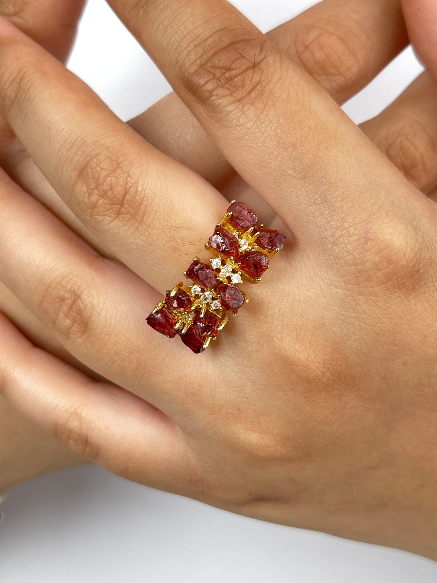 raw garnet double row ring worn on hand