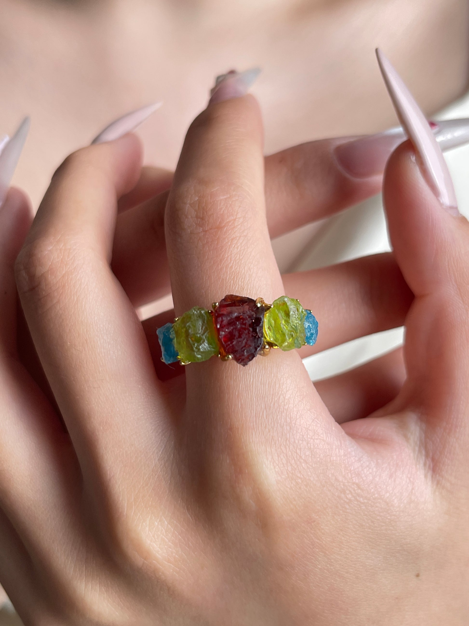 Raw Garnet, Peridot and Blue Apatite Crystal Ring worn on hand