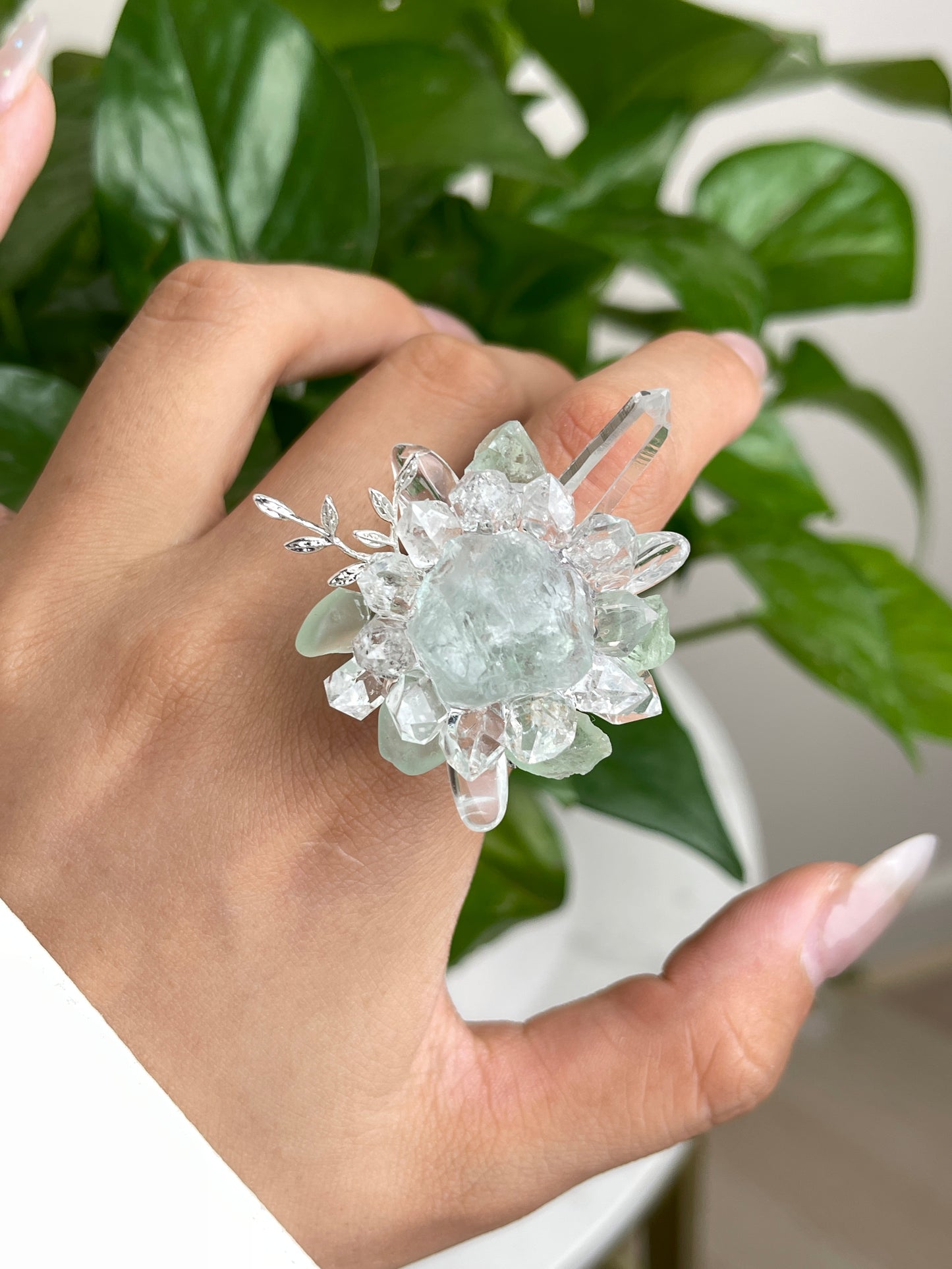 Close-up hand view of raw Green Fluorite and Herkimer Diamond Quartz crystal ring