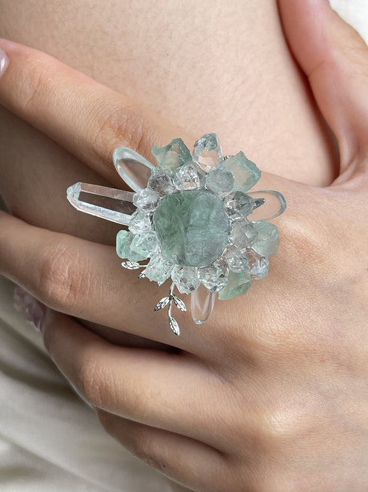 Close-up hand view of raw Green Fluorite and Herkimer Diamond Quartz crystal ring