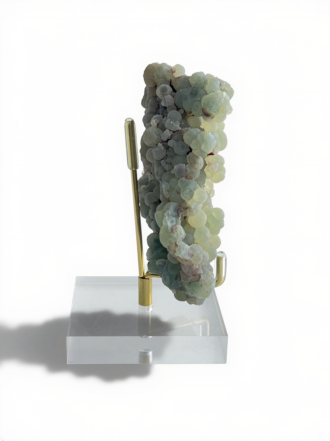 Raw green prehnite cluster mineral specimen on display stand, side view