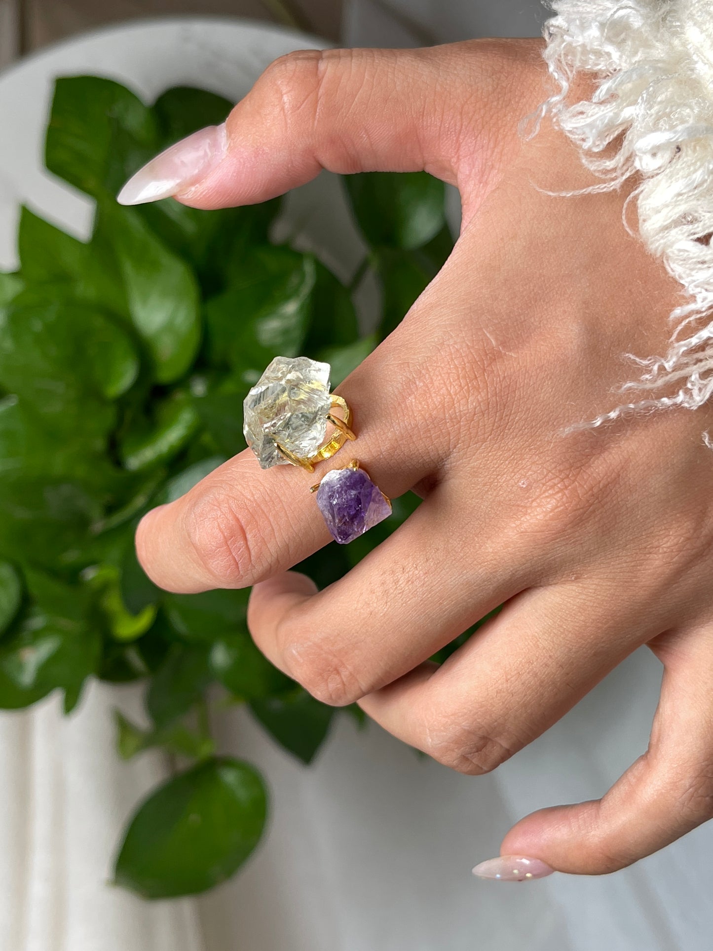 Close-up hand view of Raw Green Quartz and Amethyst crystal ring