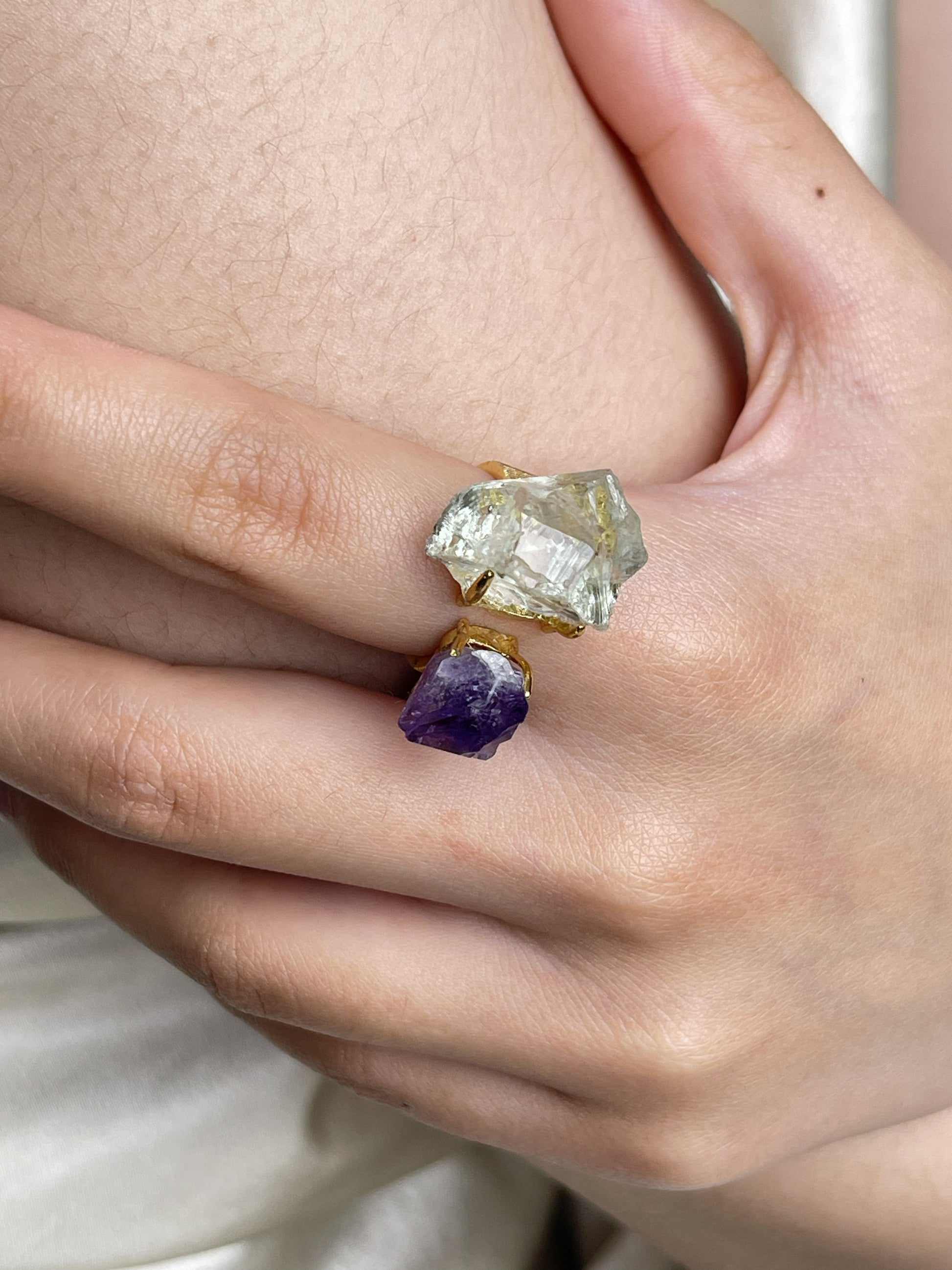 Close-up hand view of Raw Green Quartz and Amethyst crystal ring