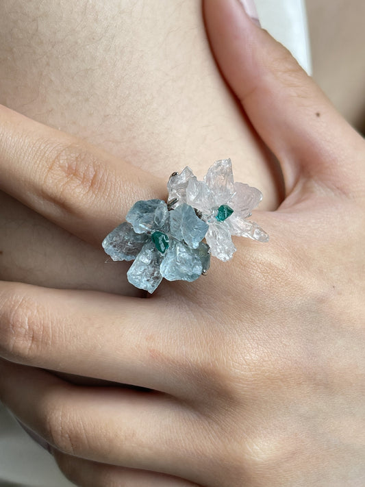 Close-up hand view of raw Morganite and Aquamarine flower ring with Dioptase centers