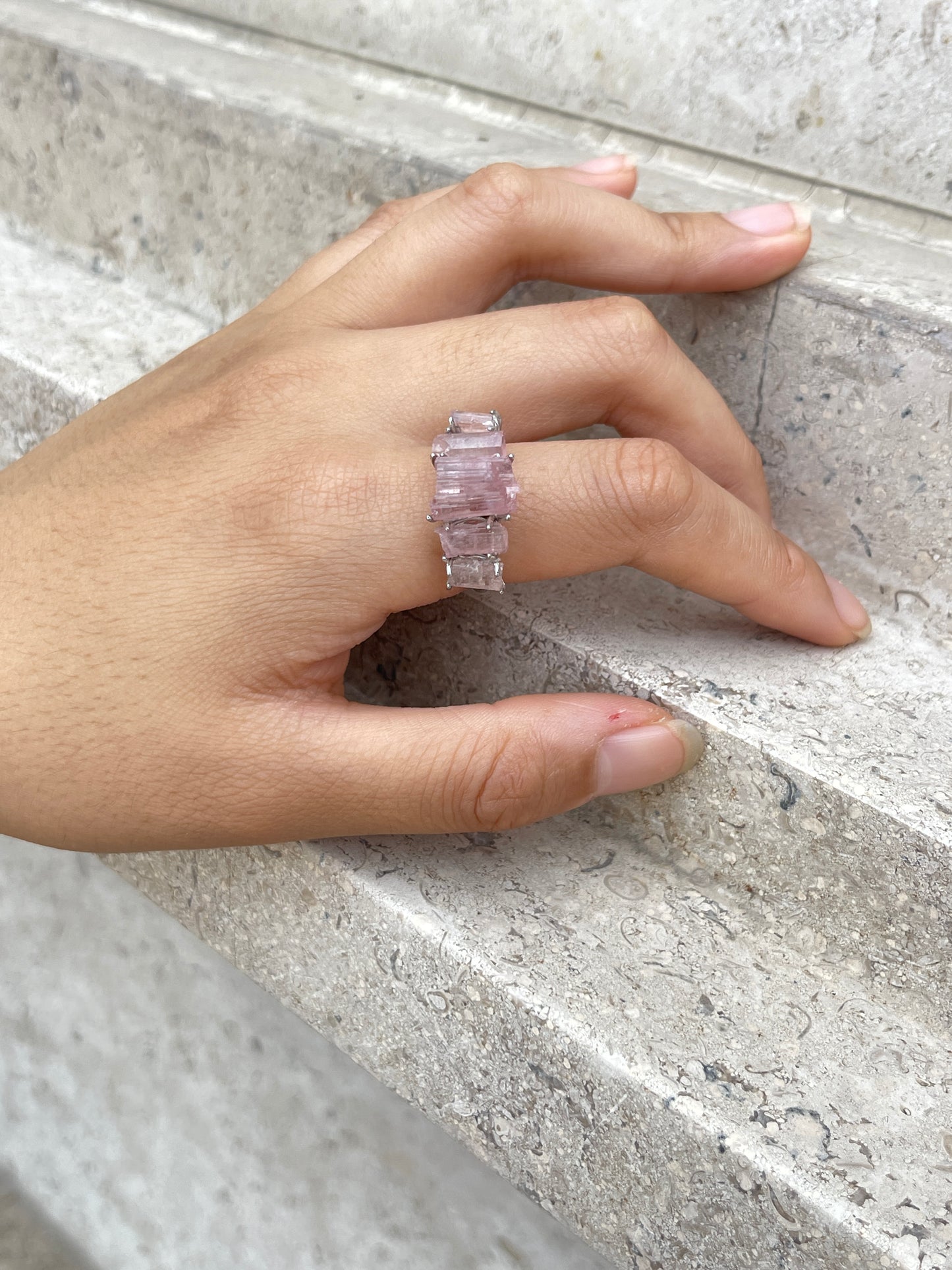Close-up hand view of Raw Morganite hexagonal column band ring