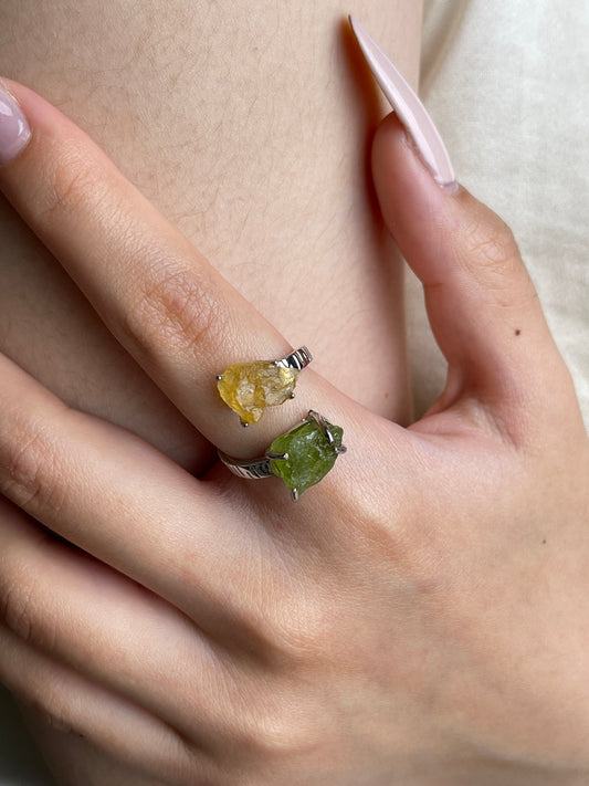 Close up of raw Peridot and Citrine ring on hand