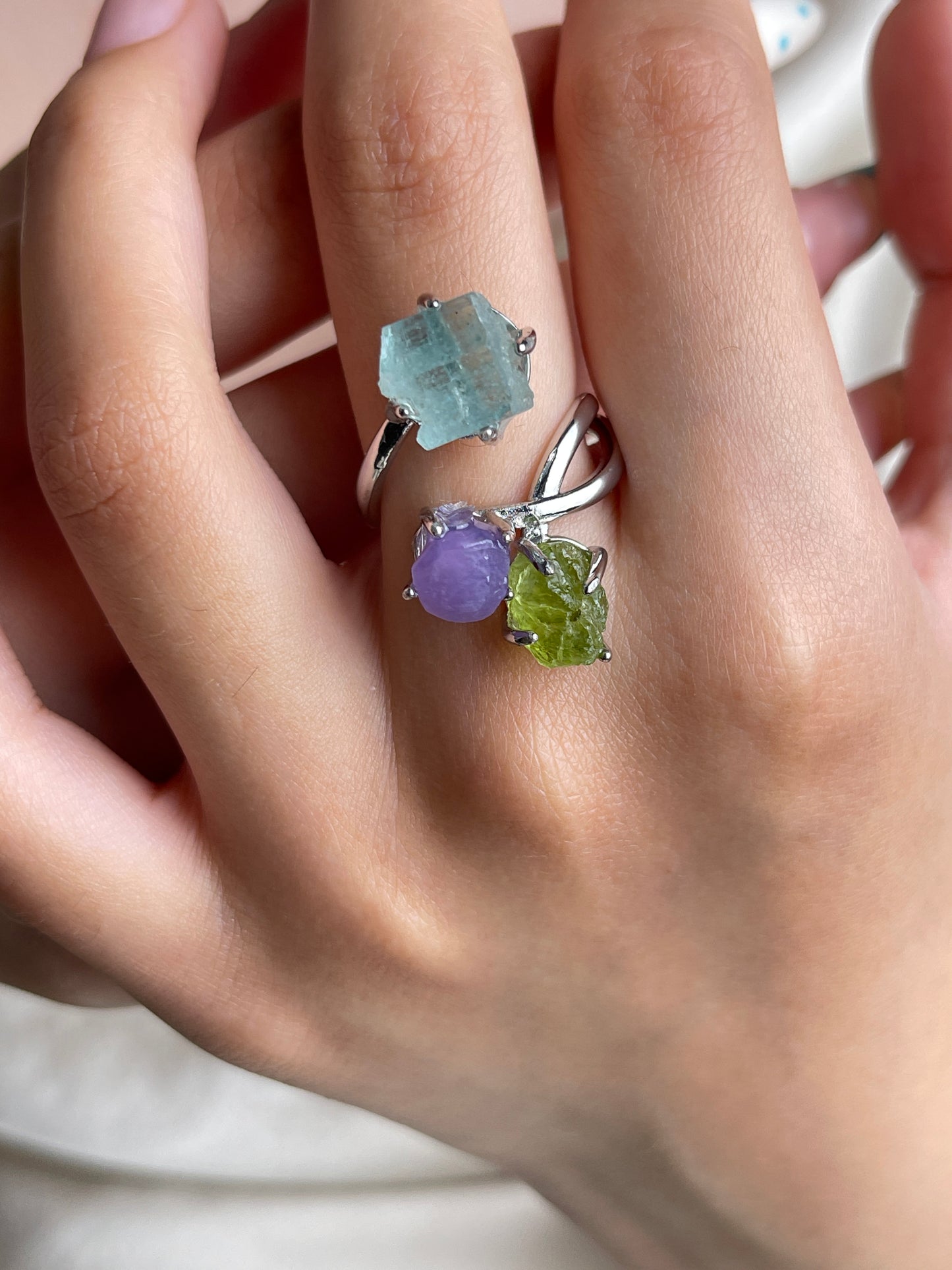 Raw peridot, purple grape agate and raw aquamarine crystal ring worn on hand