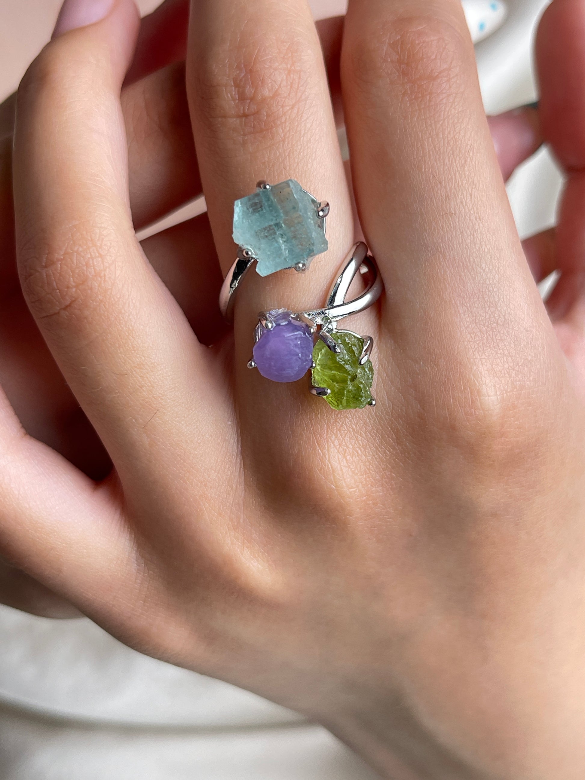 Raw peridot, purple grape agate and raw aquamarine crystal ring worn on hand