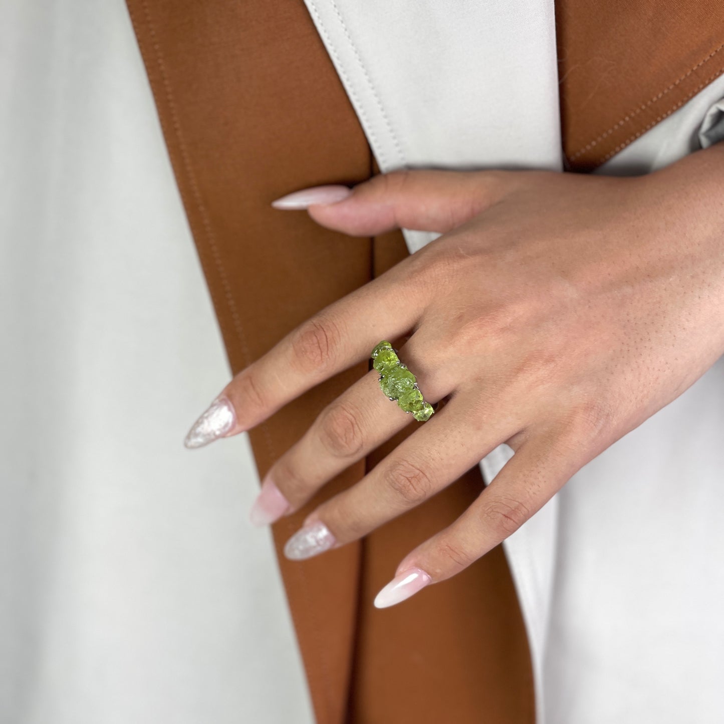 close up look raw peridot crystal ring
