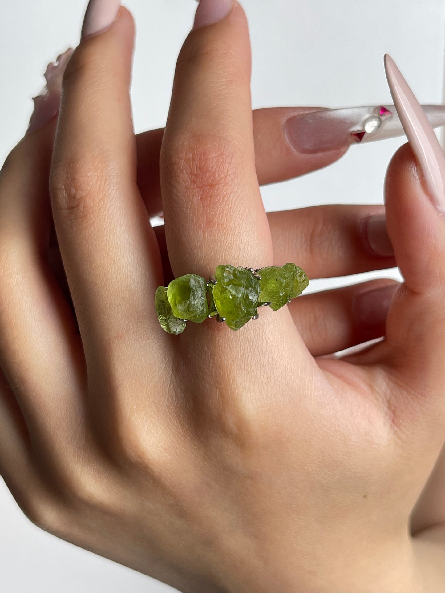raw peridot crystal ring worn on hand by oryssia