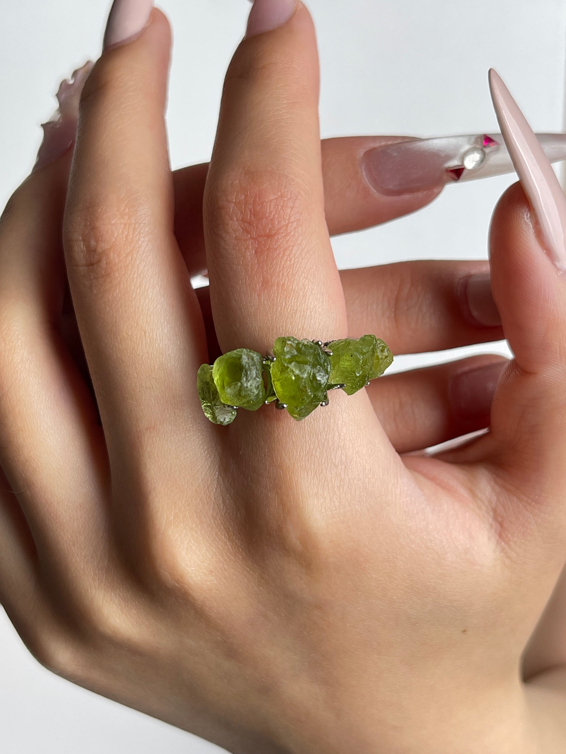 raw peridot crystal ring worn on hand by oryssia