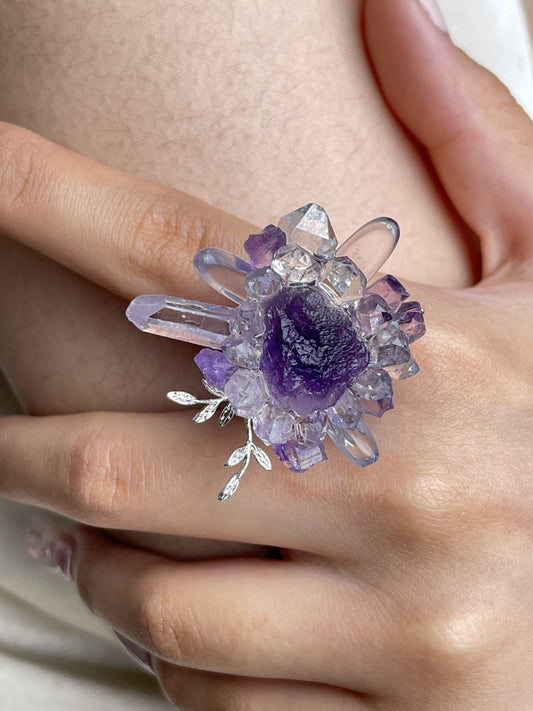 Close-up hand view of raw Purple Fluorite, Amethyst and Herkimer Diamond Quartz crystal ring