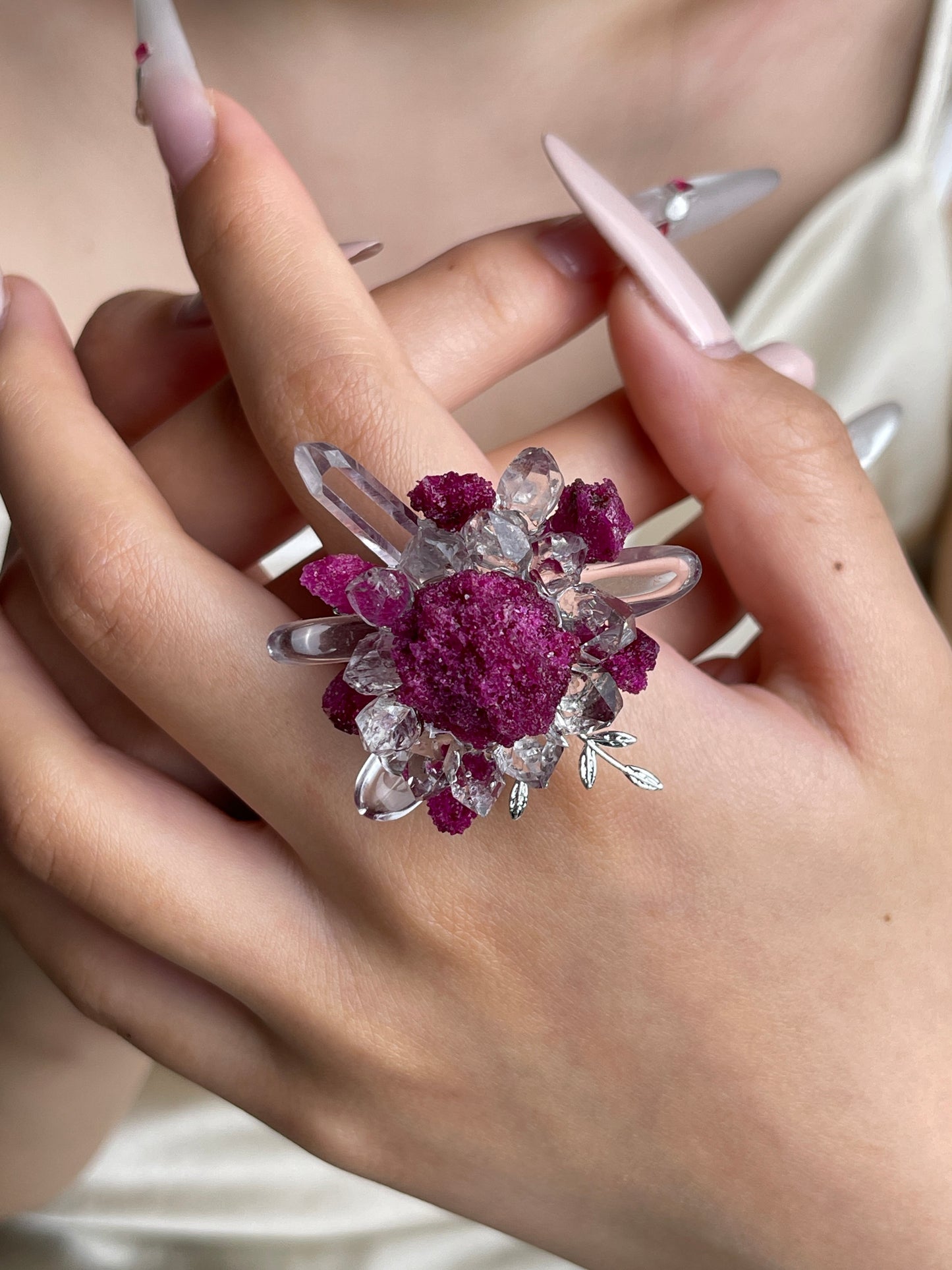 Raw ruby and quartz flower ring worn on hand