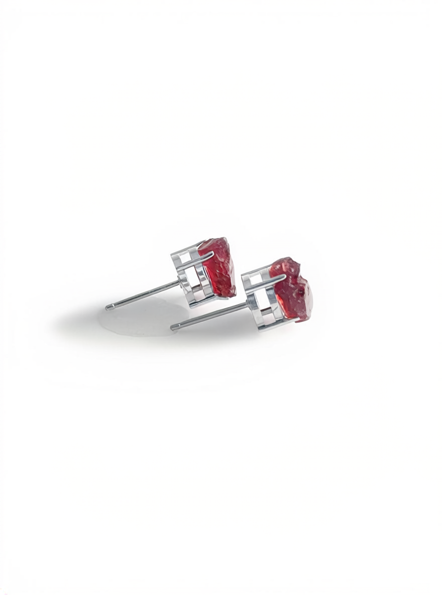 Side view of raw Sri Lankan garnet stud earrings