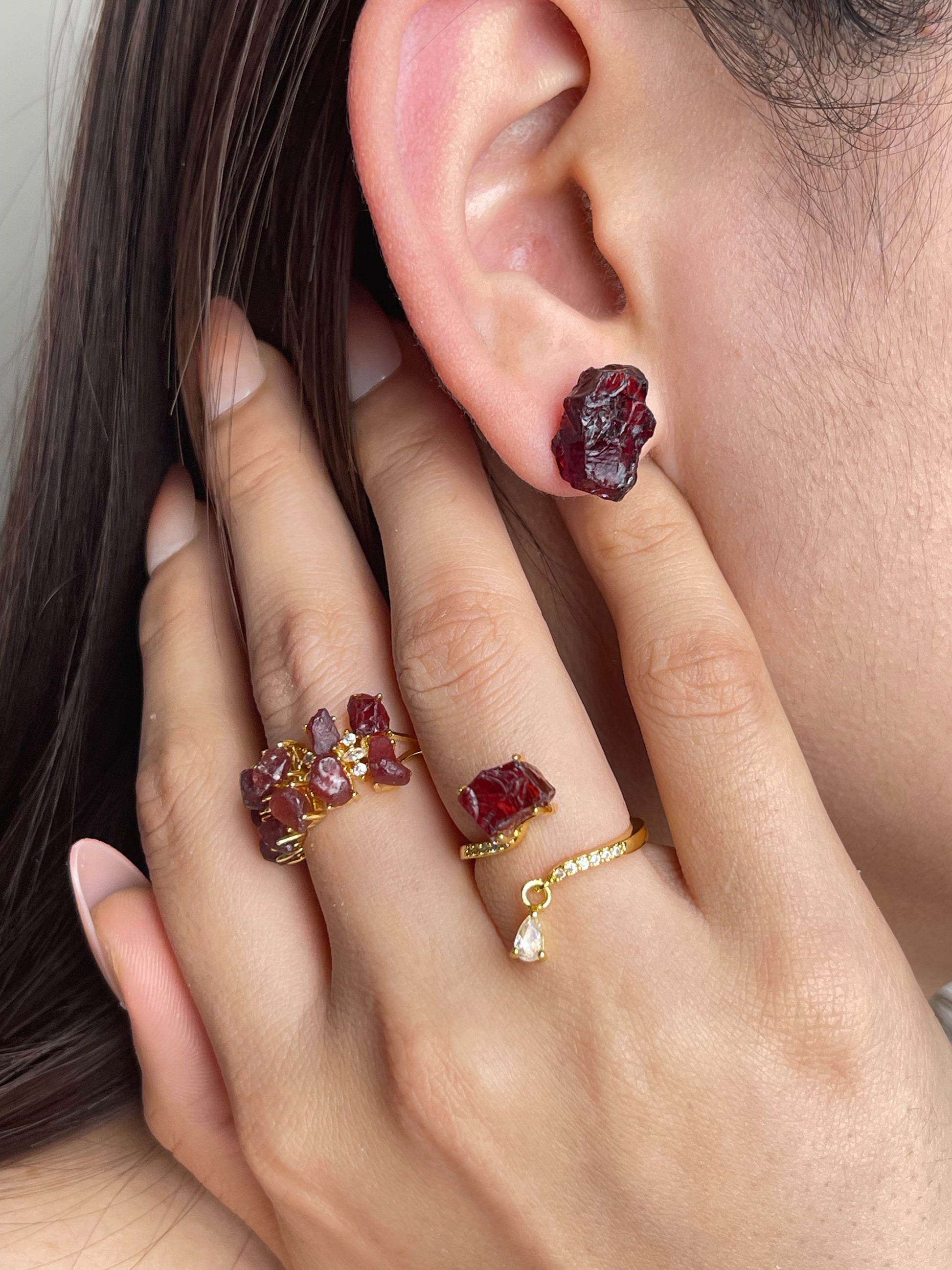 Raw Sri Lankan garnet stud earrings worn with natural crystal jewelry styling