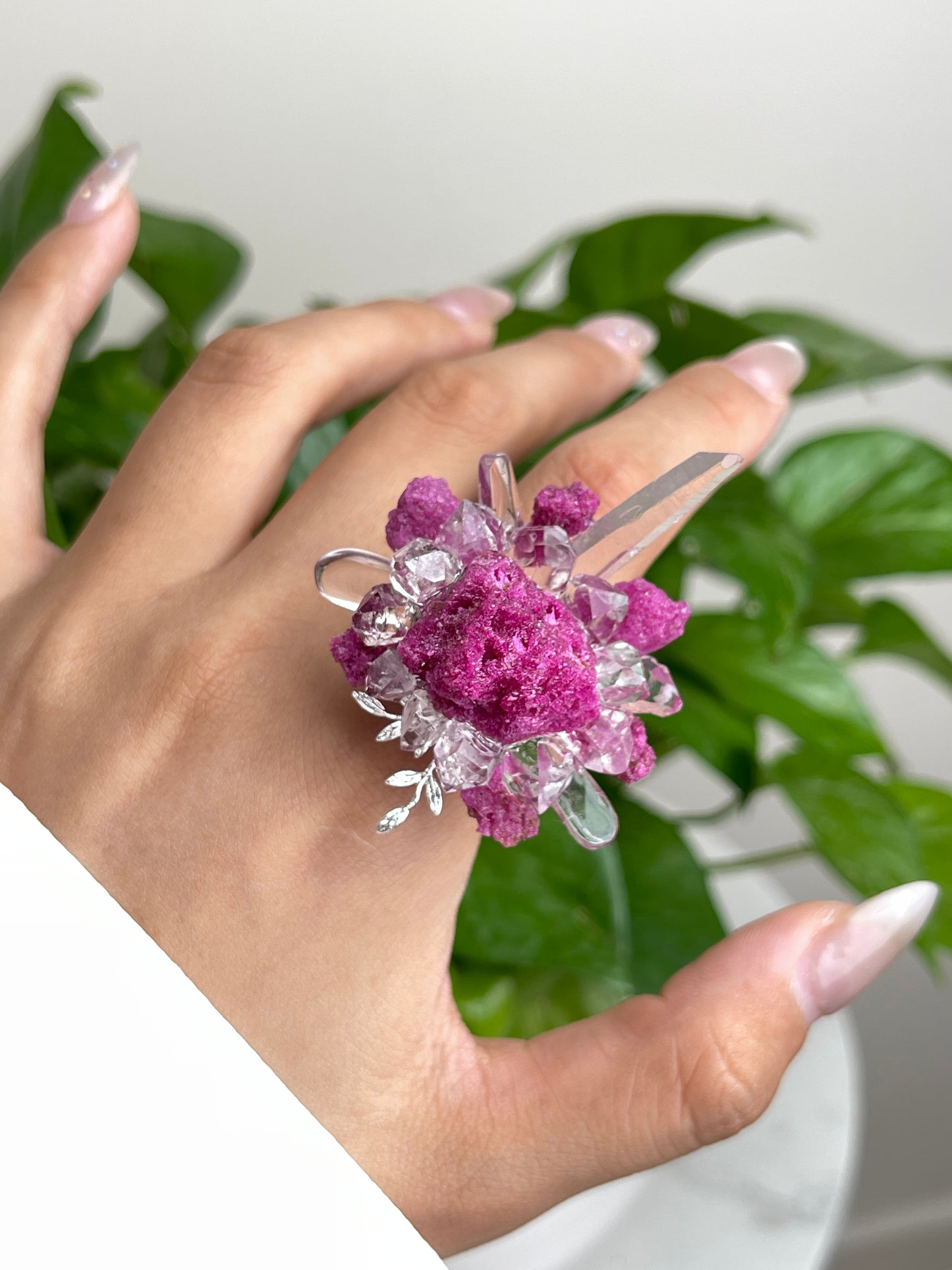 Close up of raw ruby Herkimer Diamond Quartz and clear quartz flower ring worn on hand