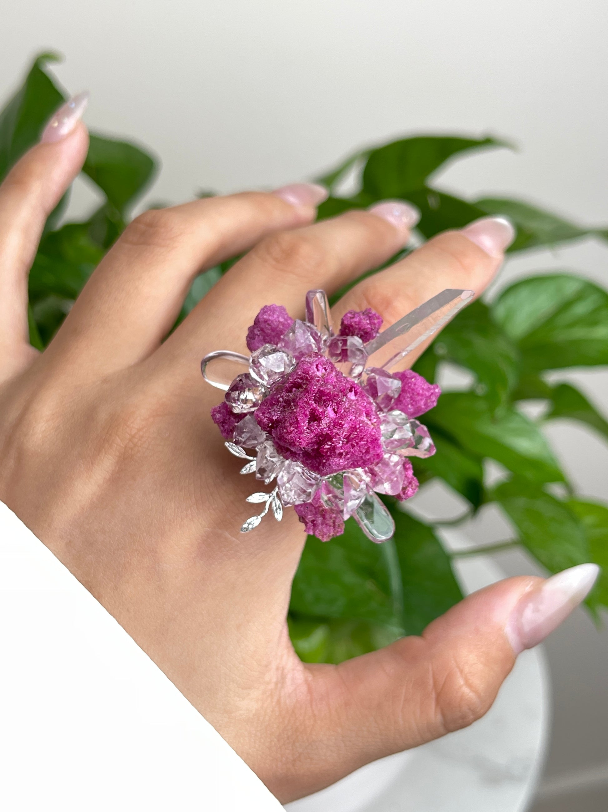 Close up of raw ruby Herkimer Diamond Quartz and clear quartz flower ring worn on hand