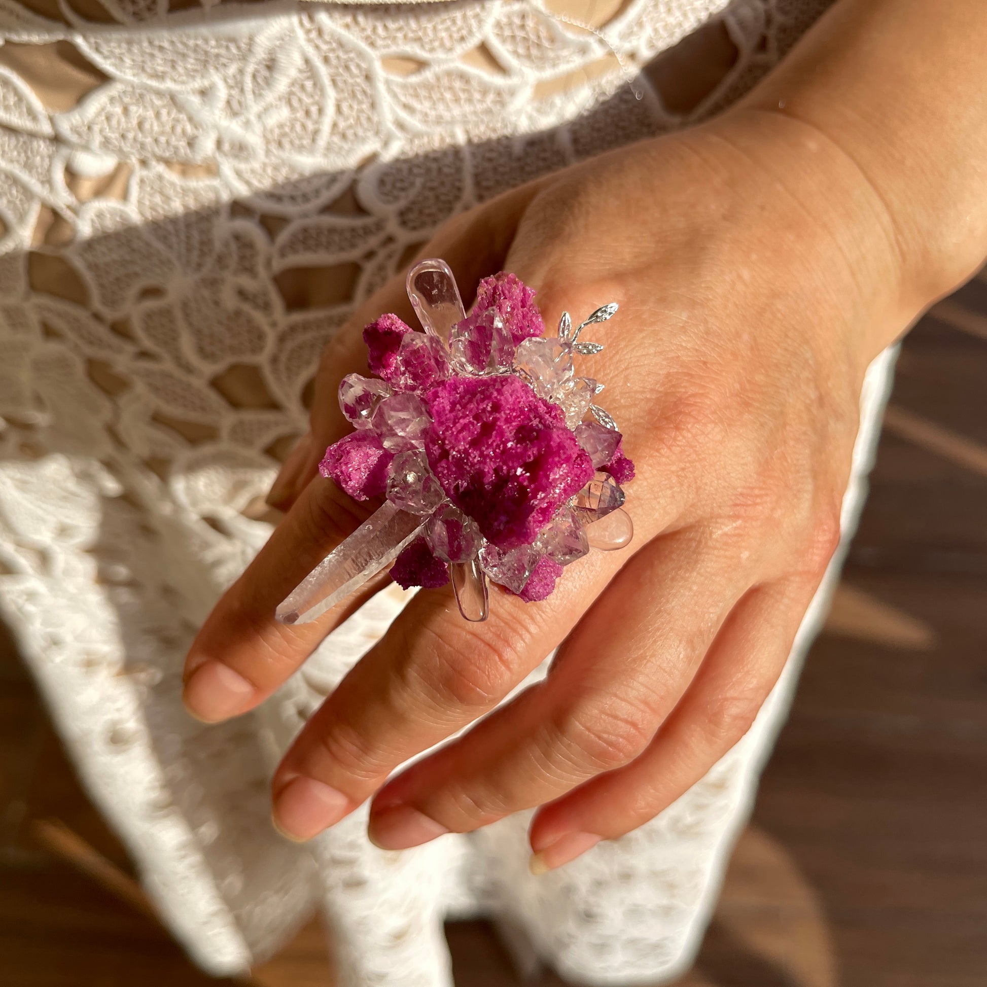Close up of raw ruby Herkimer Diamond Quartz and clear quartz flower ring worn on hand