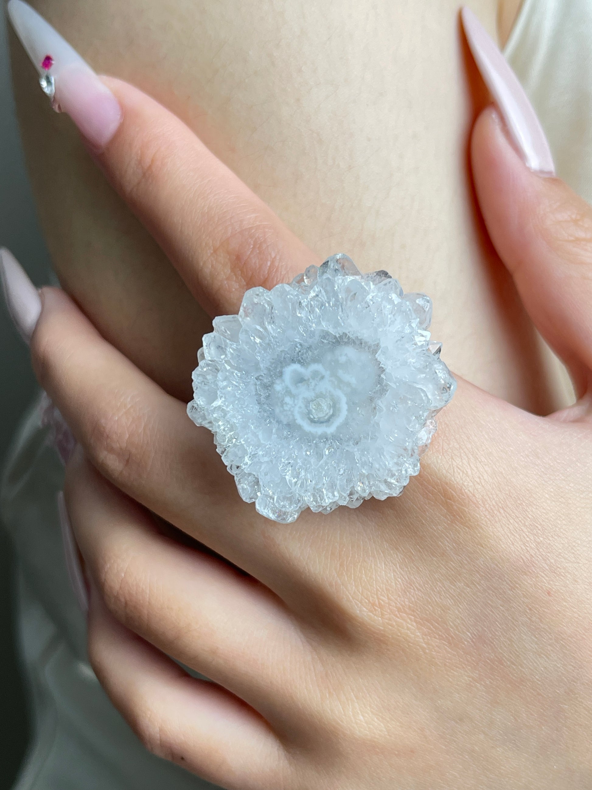 Close-up of Solar Quartz Slice Ring worn on hand