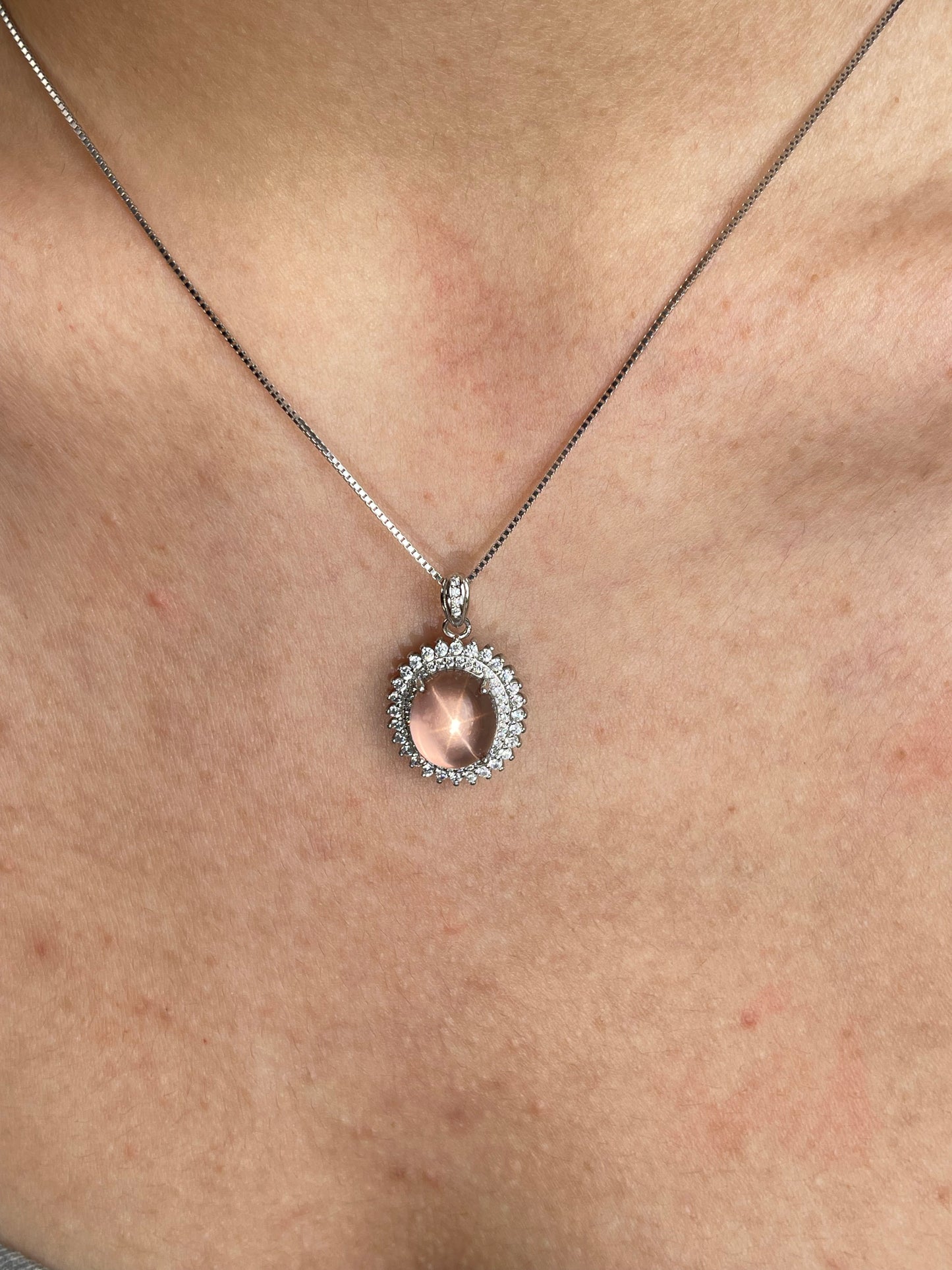 Close-up of star rose quartz necklace Madagascar worn on neck