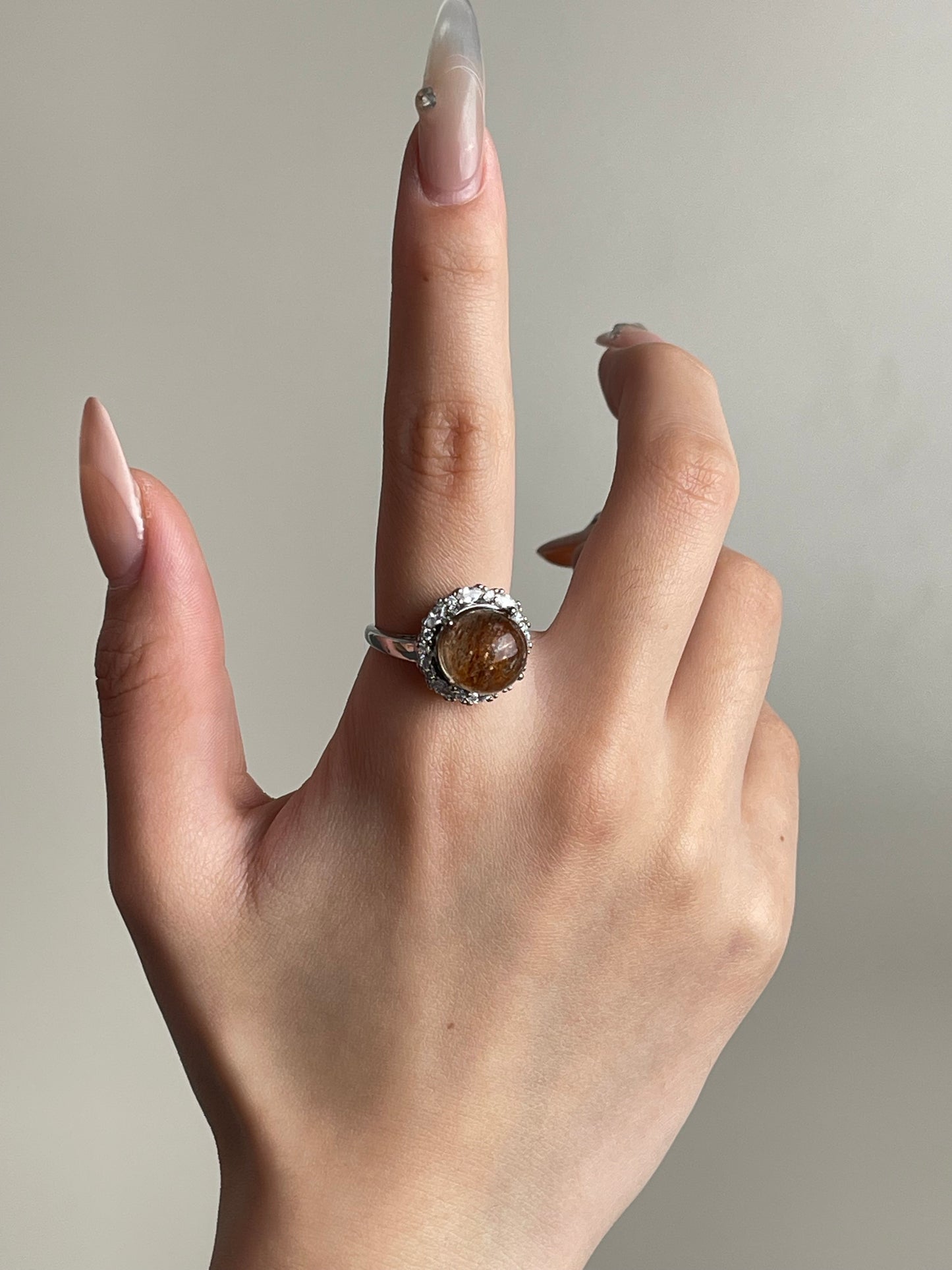 super seven quartz sphere ring worn on hand