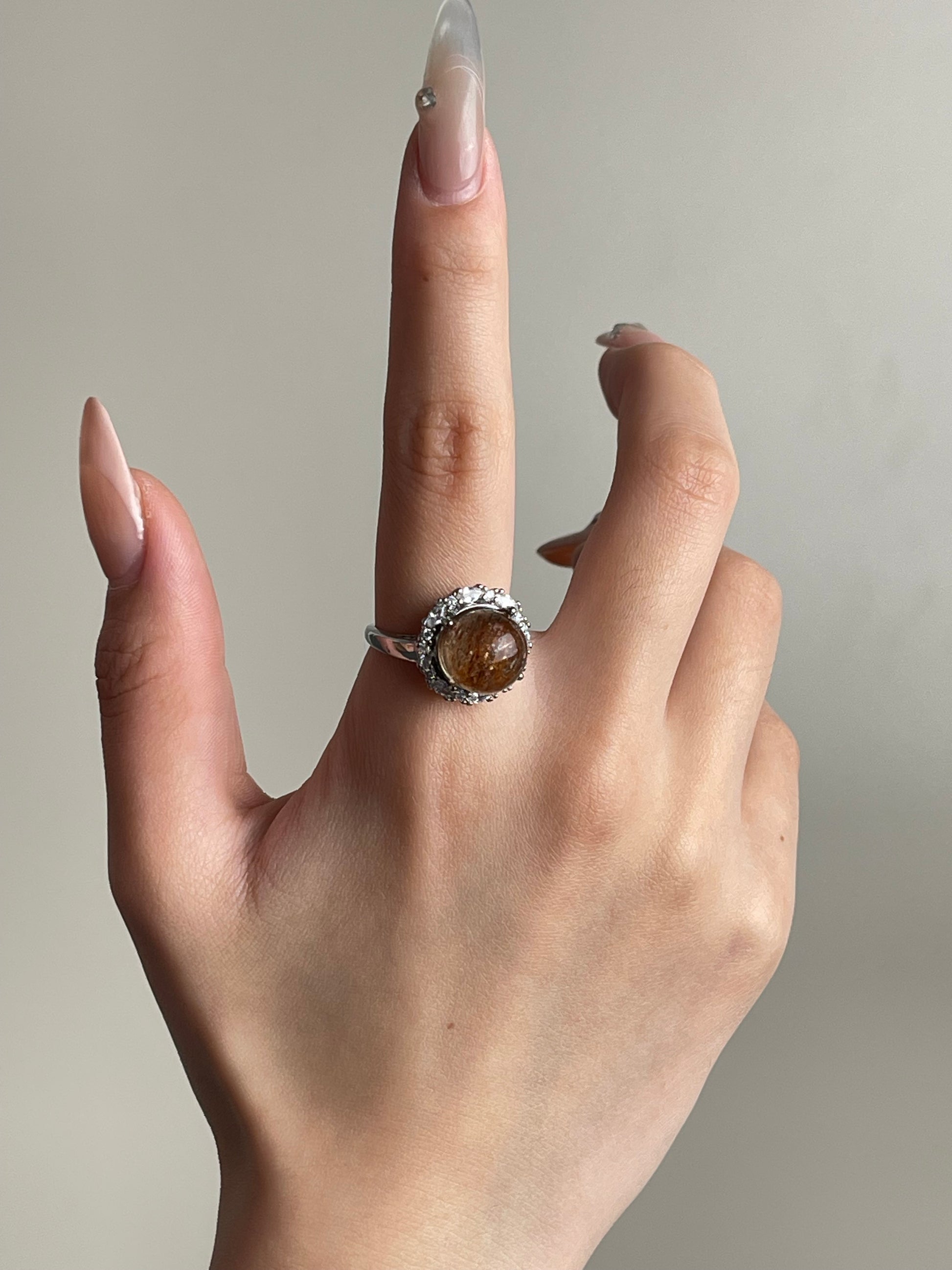 super seven quartz sphere ring worn on hand