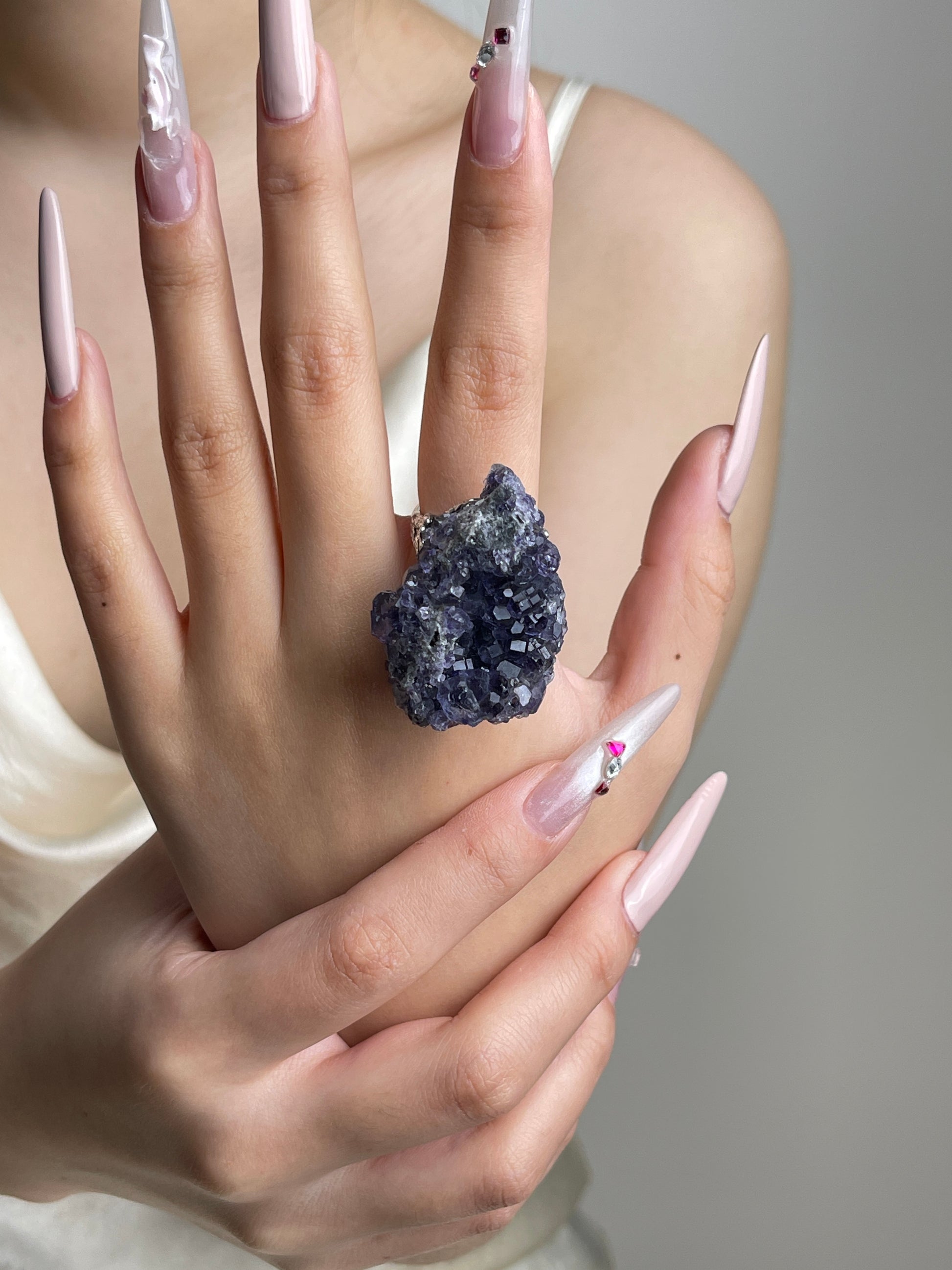 Tanzanite-colored Fluorite mineral specimen ring worn on hand