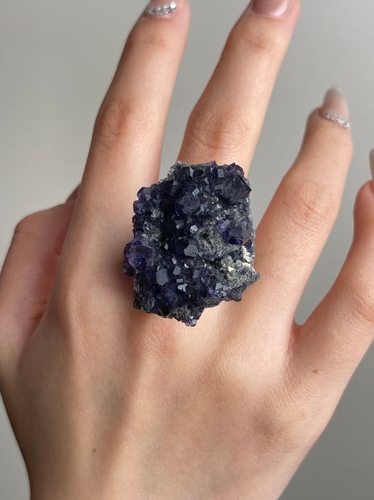 Close-up hand shot of tanzanite fluorite ring