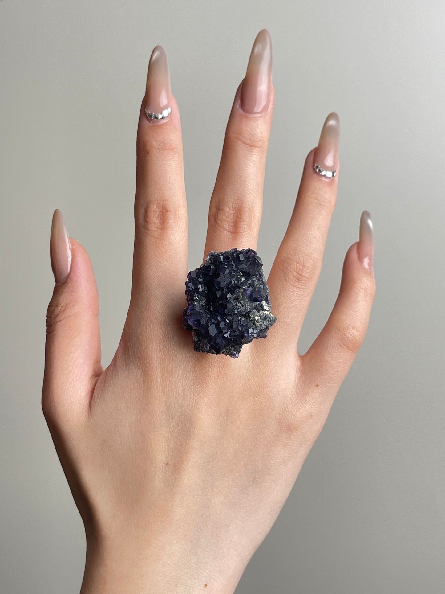 Hand shot of tanzanite fluorite ring