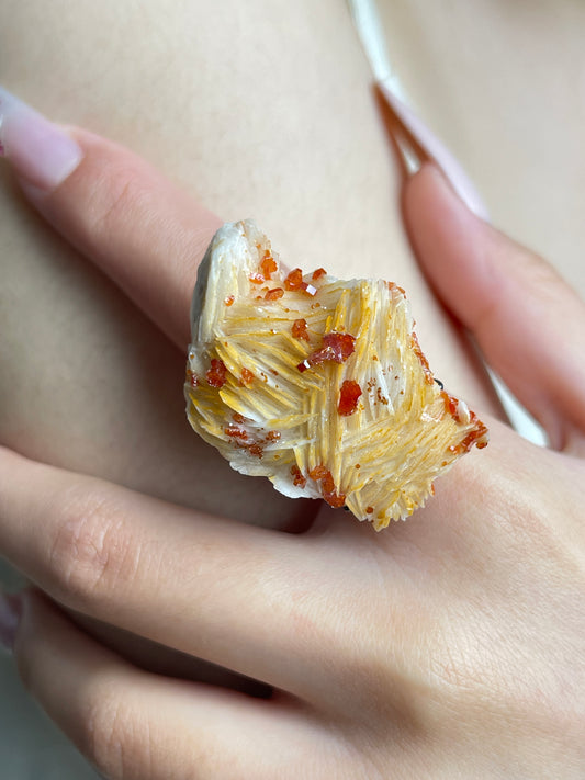 Close-up of Vanadinite on Barite mineral specimen ring worn on hand