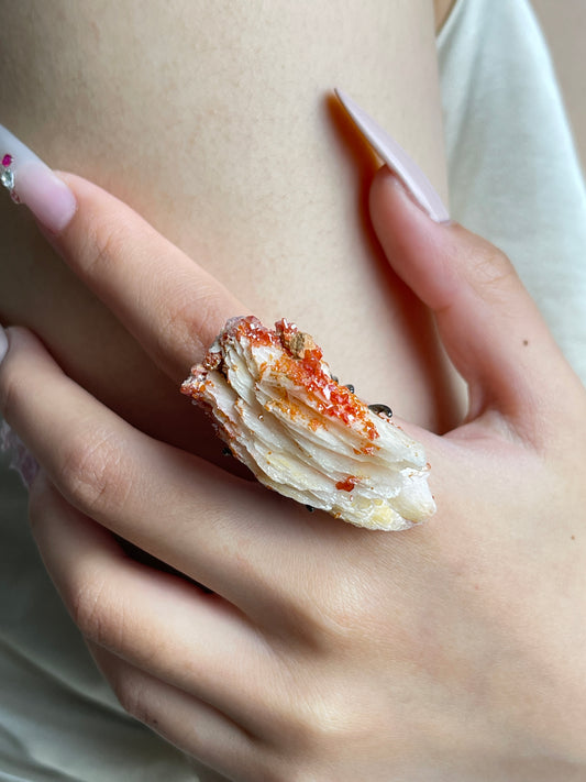 Close-up of Vanadinite on Barite mineral specimen ring worn on hand